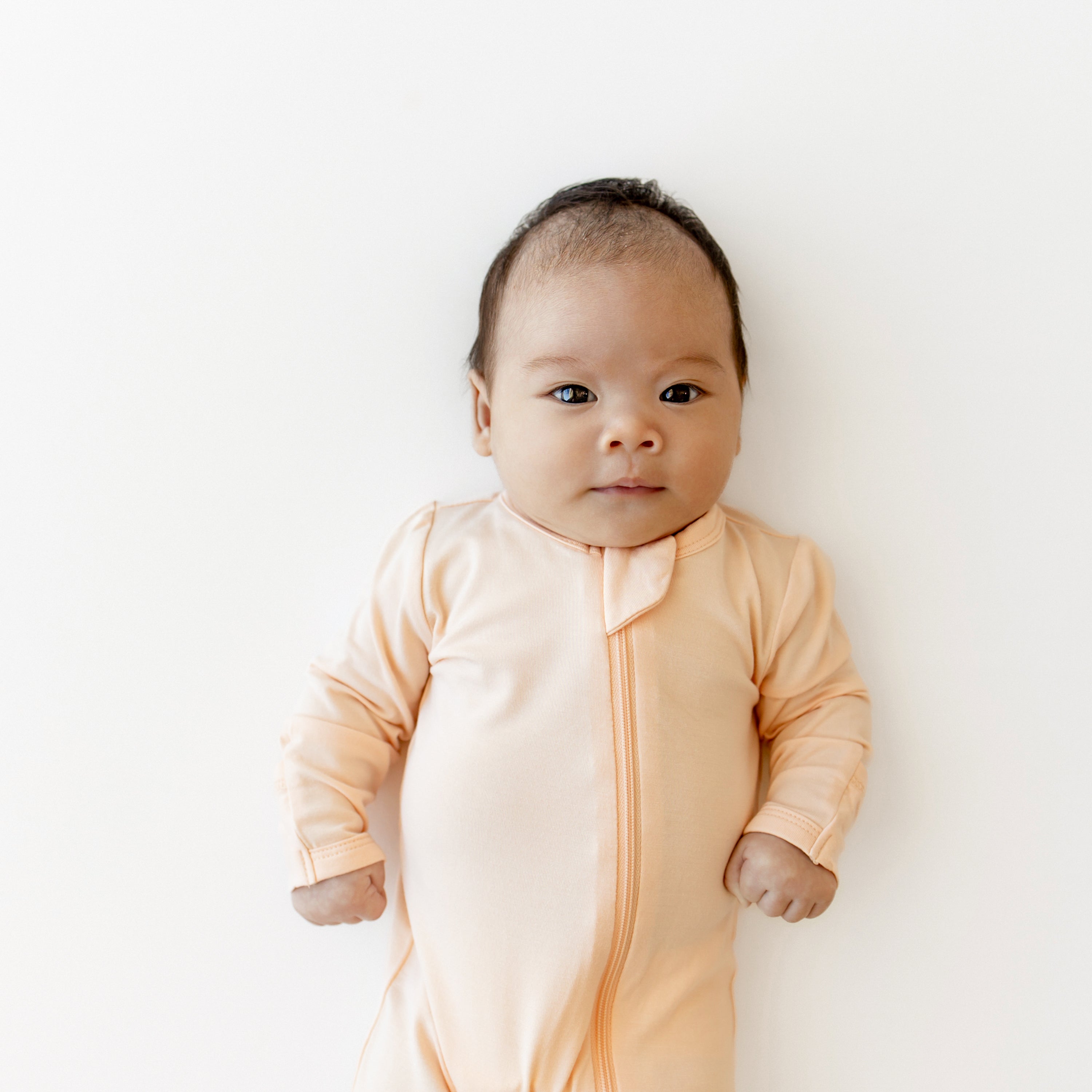 Baby waring kids footie pajamas with zipper in Canyon