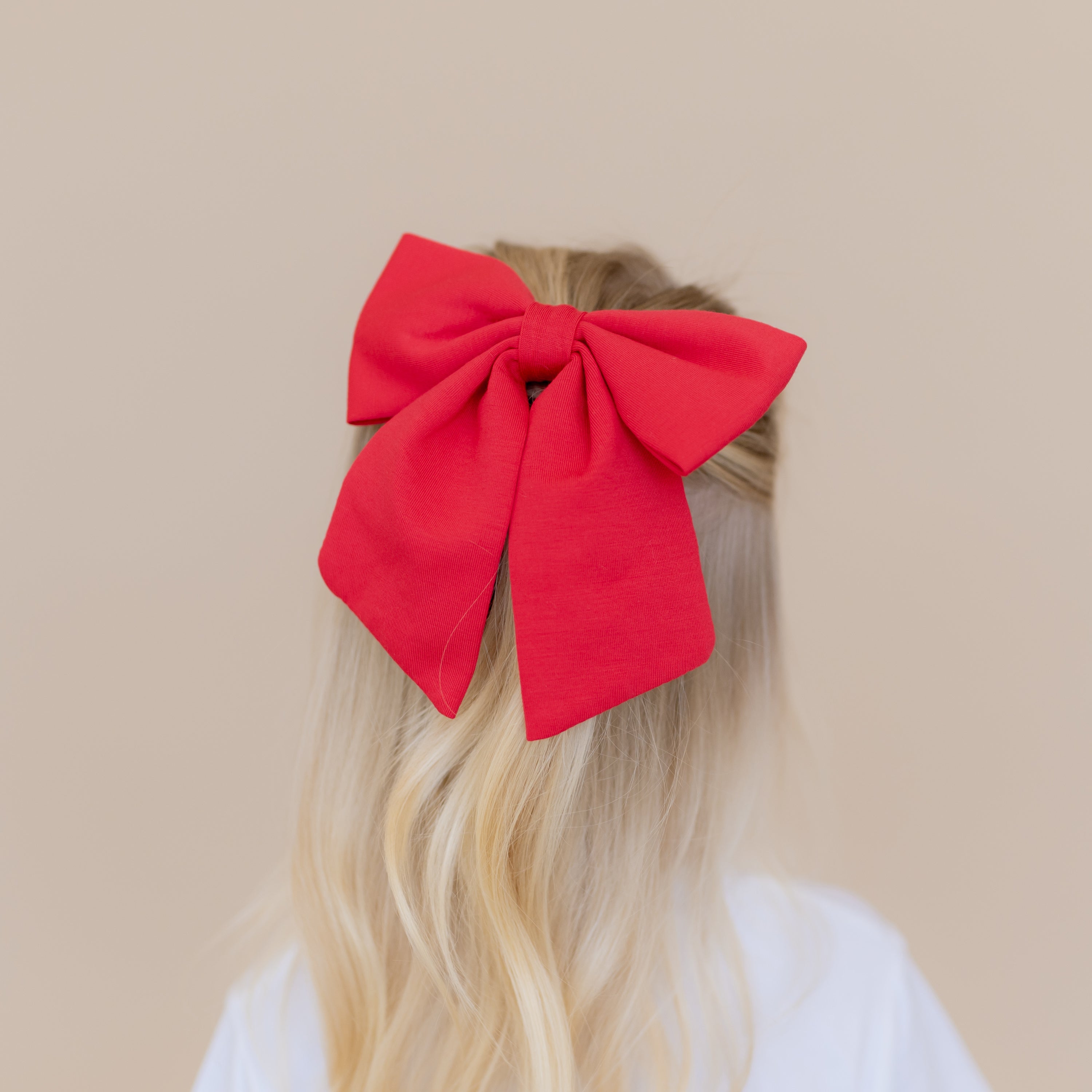 Large Alligator Clip Bow in Cardinal shown in young girls hair
