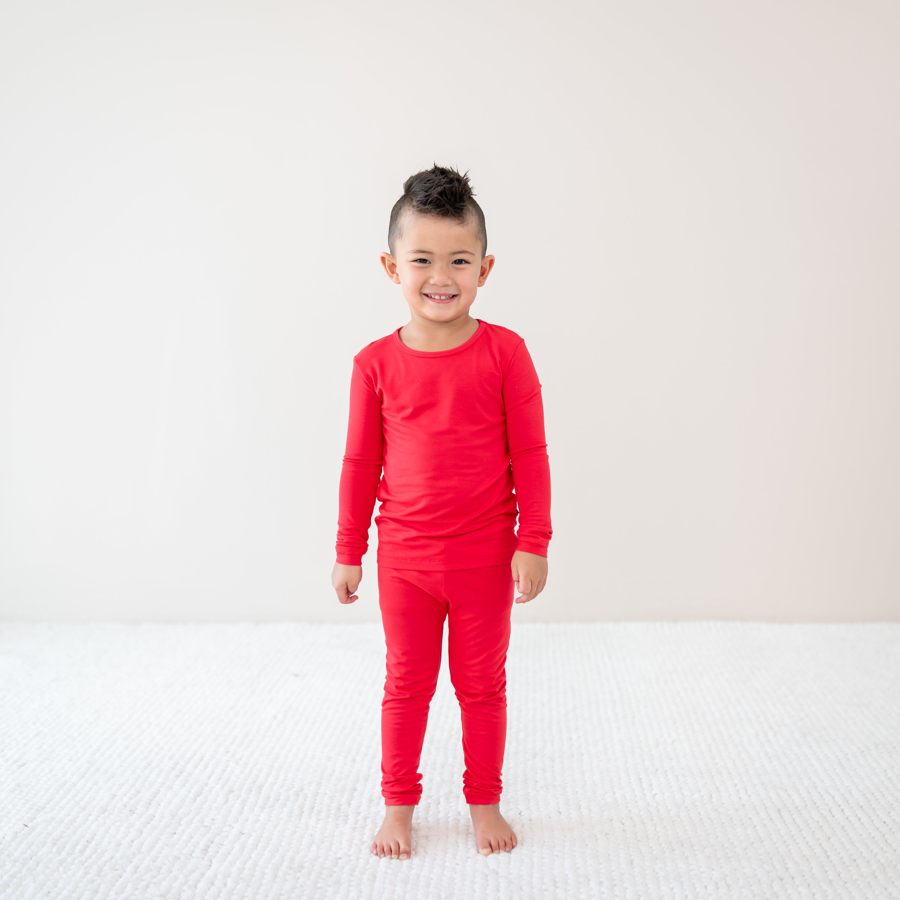 Child modeling Long Sleeve Pajamas in Cardinal