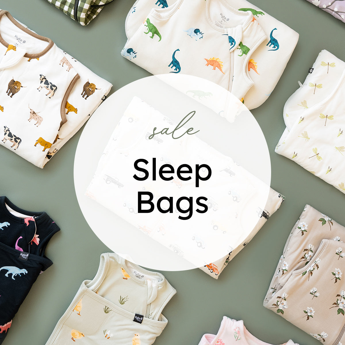 A styled flat-lay of multiple folded baby sleep bags and bodysuits in soft neutral tones, each with different animal and nature prints, arranged around a large white circular overlay that reads 'sale Sleep Bags'. No person, animal, or real environment is present, so this is Product/Packaging rather than Lifestyle.