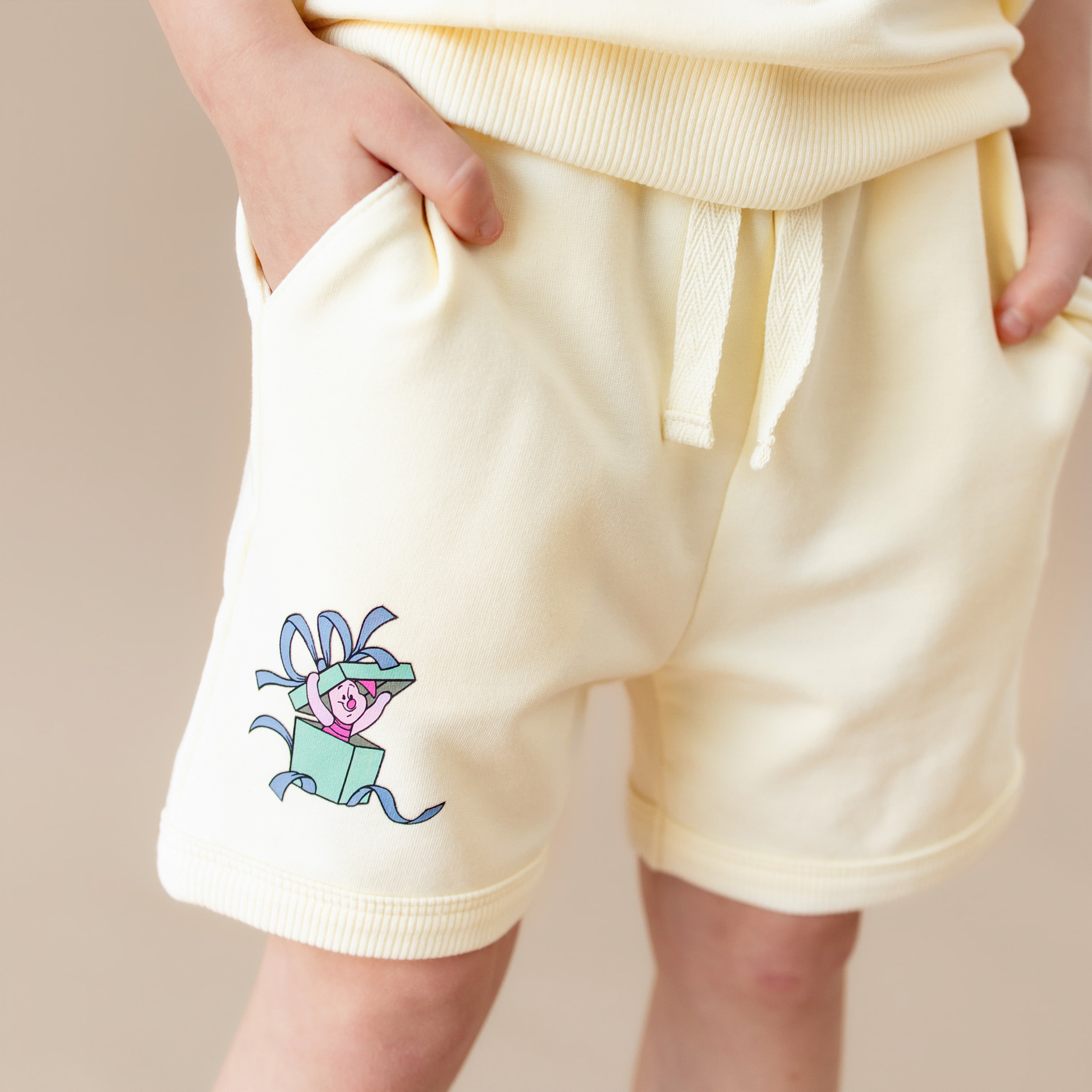 Close up of the piglet character on the shorts shown on the Short Sleeve Jogger Set in Winnie the Pooh on Chamomile