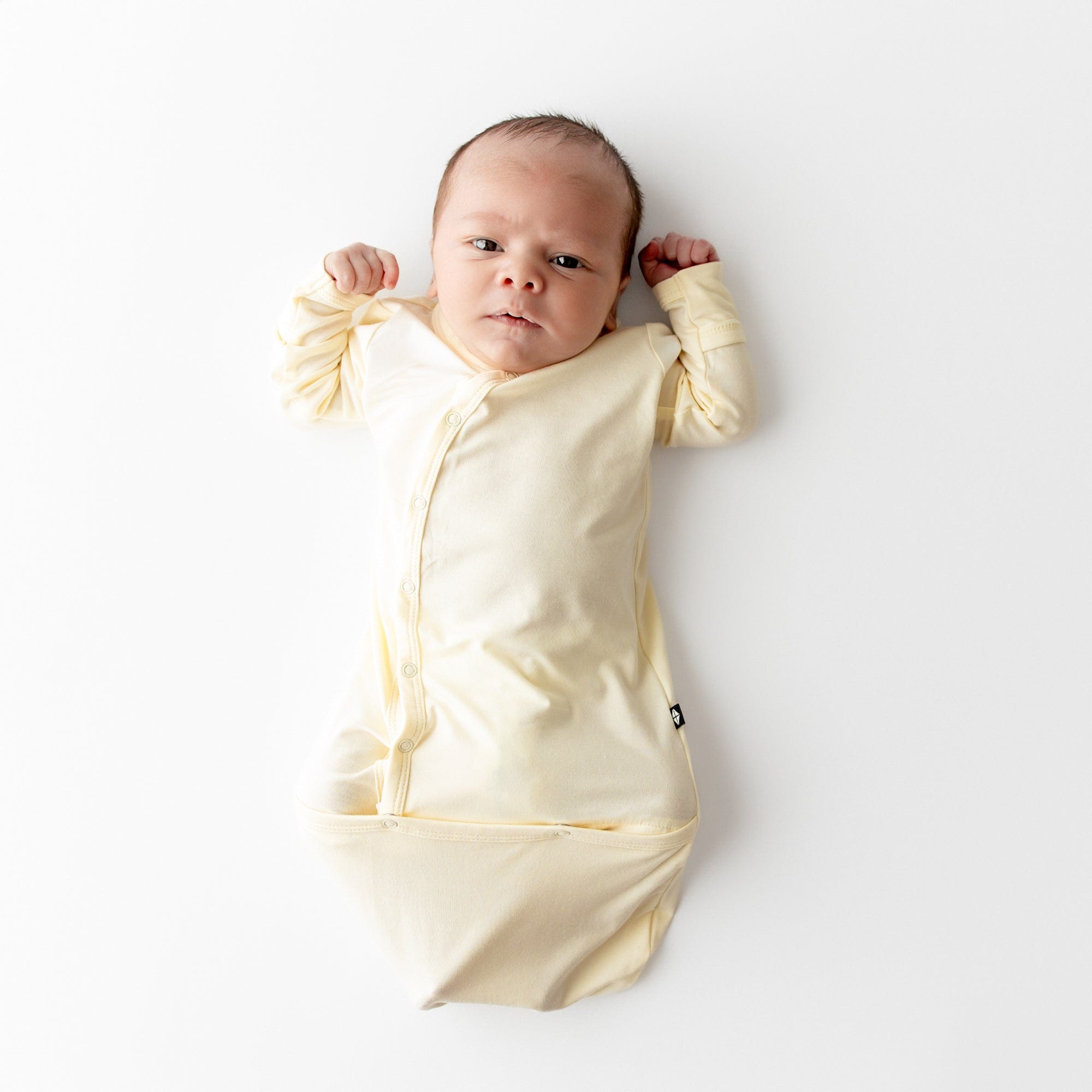 Newborn wearing Bundler in a pale yellow color