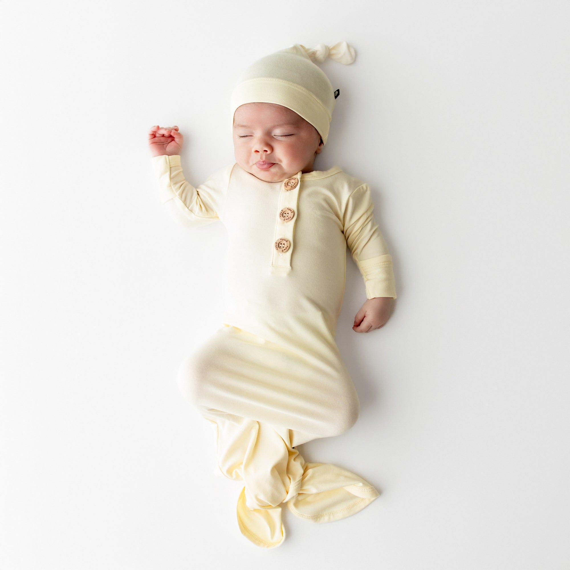 Baby sleeping in Knotted Gown with Hat Set in Chamomile