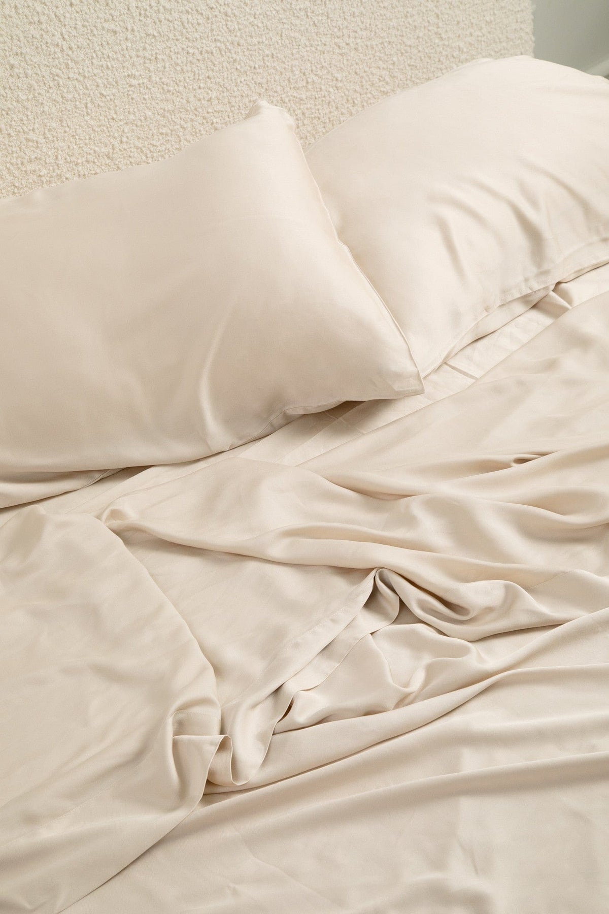 Close up of the Bamboo Sateen Sheet Set in Champagne shown on a bed