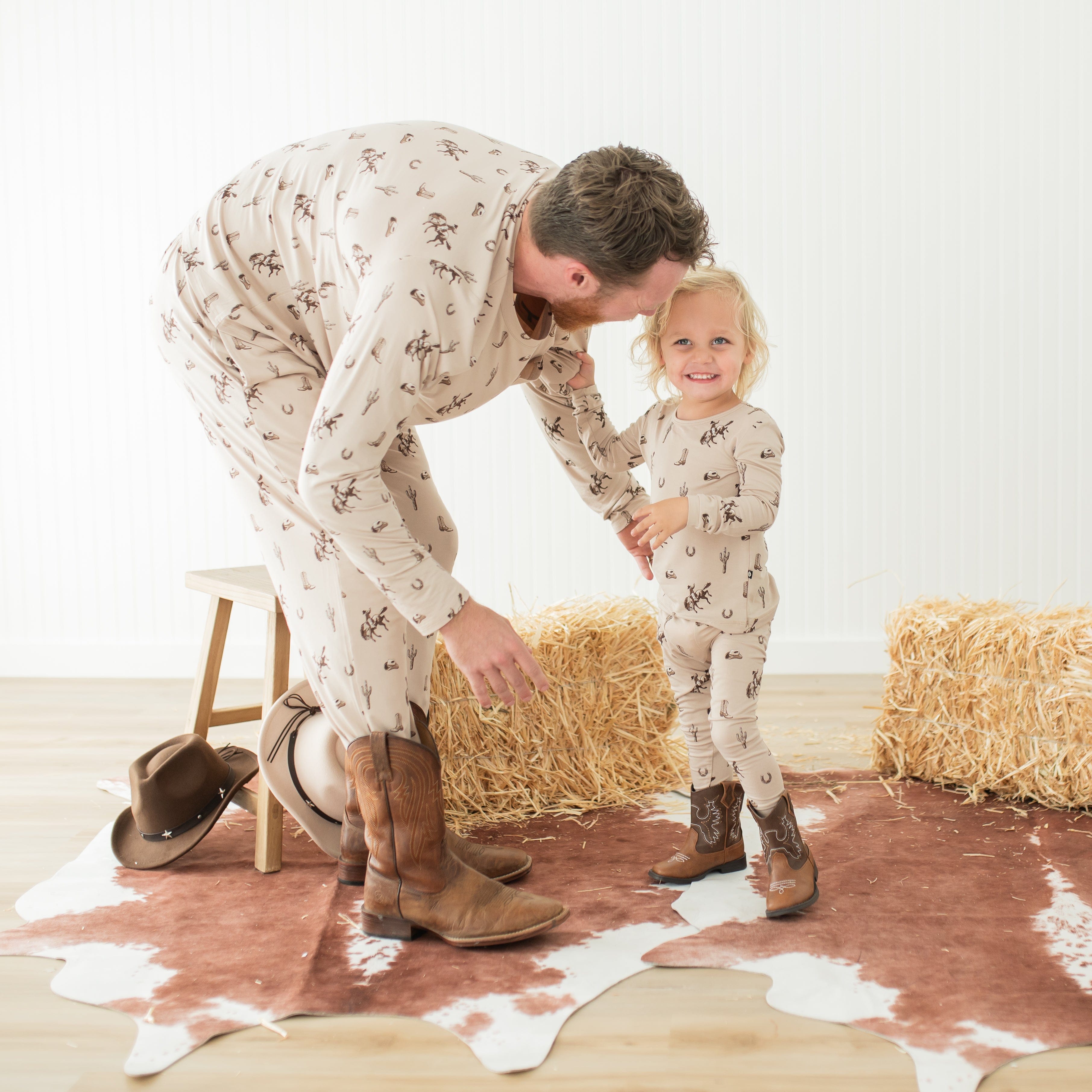 Father and child both matching in Classic Cowboy pajamas and cowboy boots