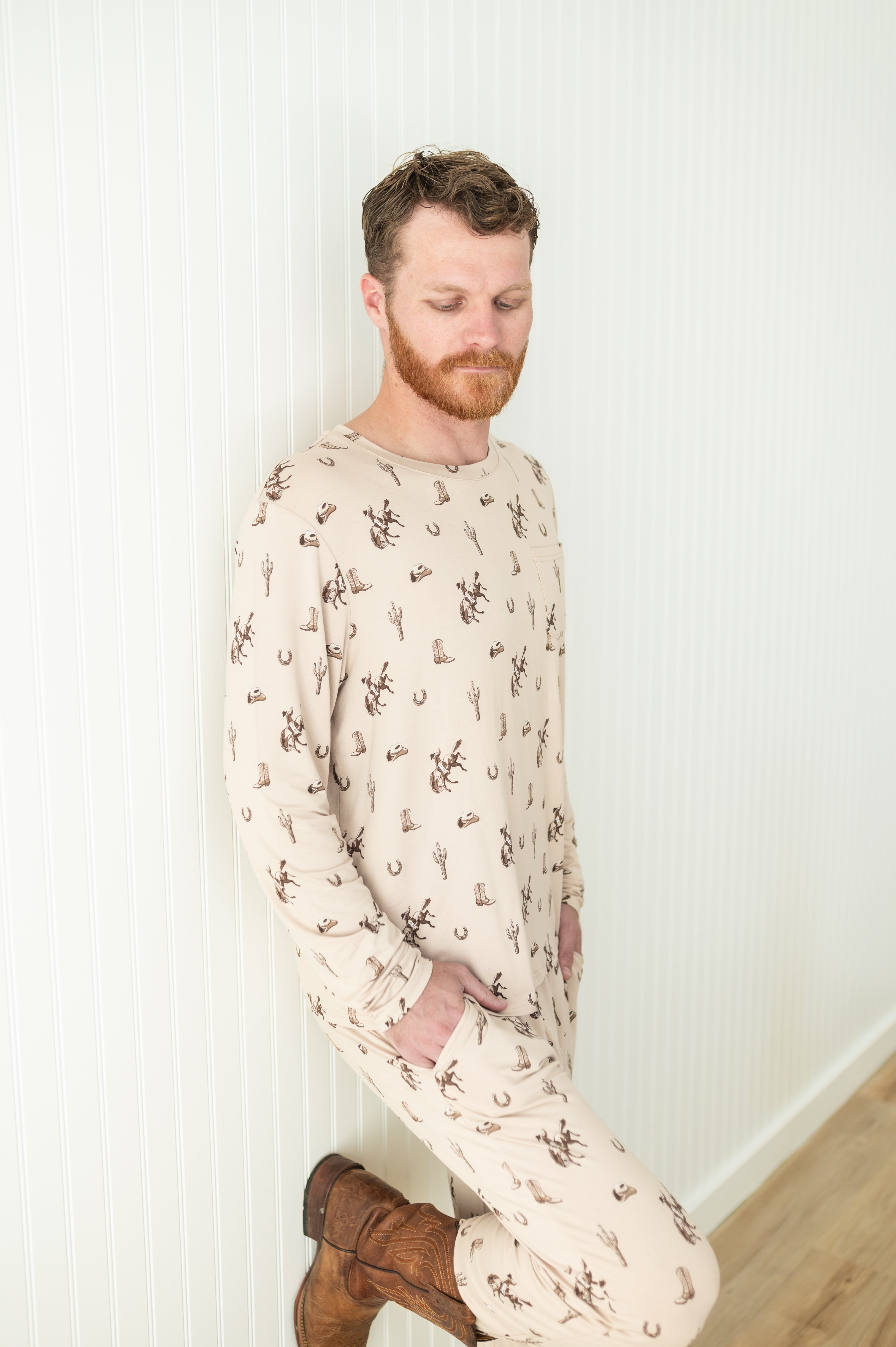 Male model wearing the Men's Jogger Set in Classic Cowboy leaning against a white paneled wall