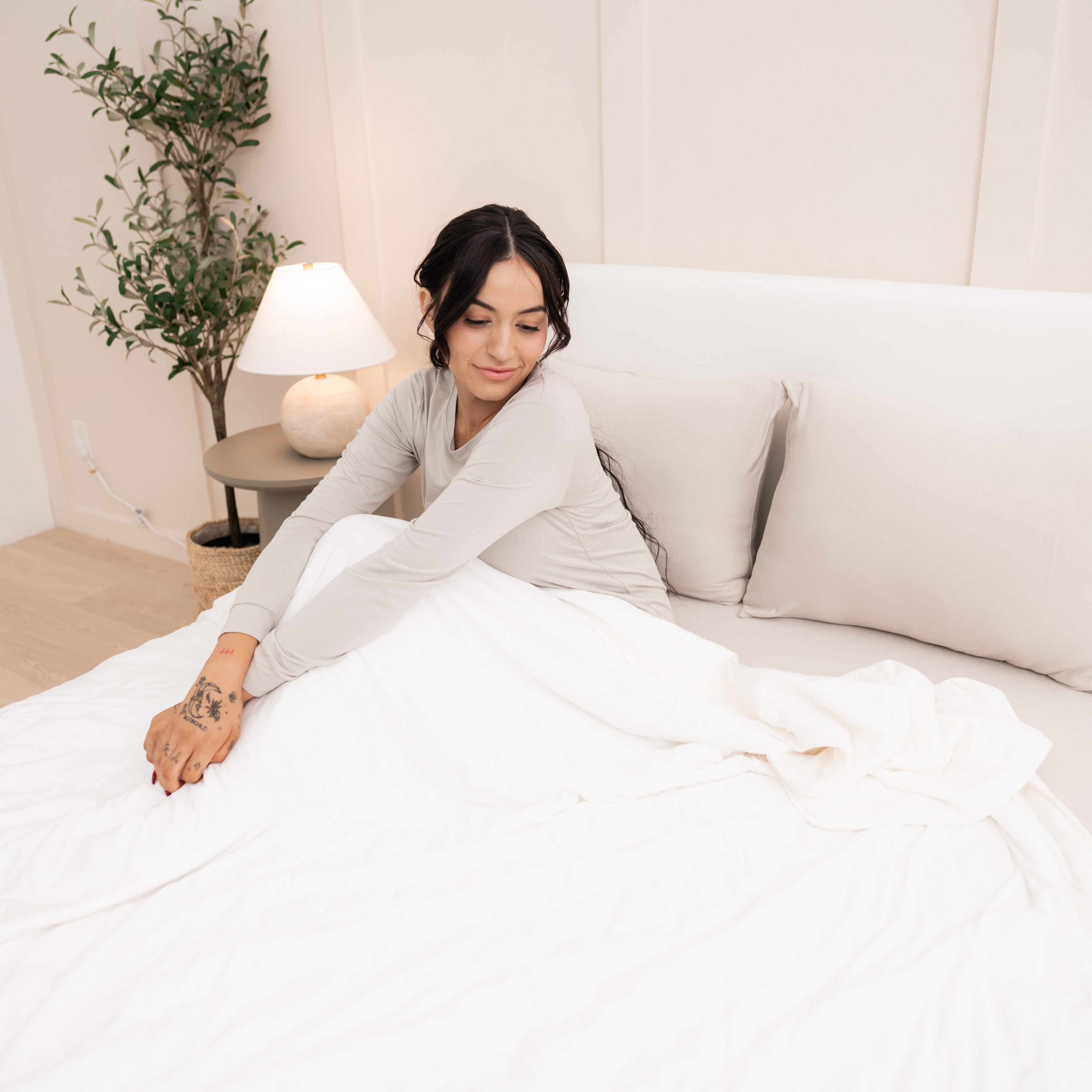 Woman in bed with Adult Quilted Blanket in Cloud 1.0