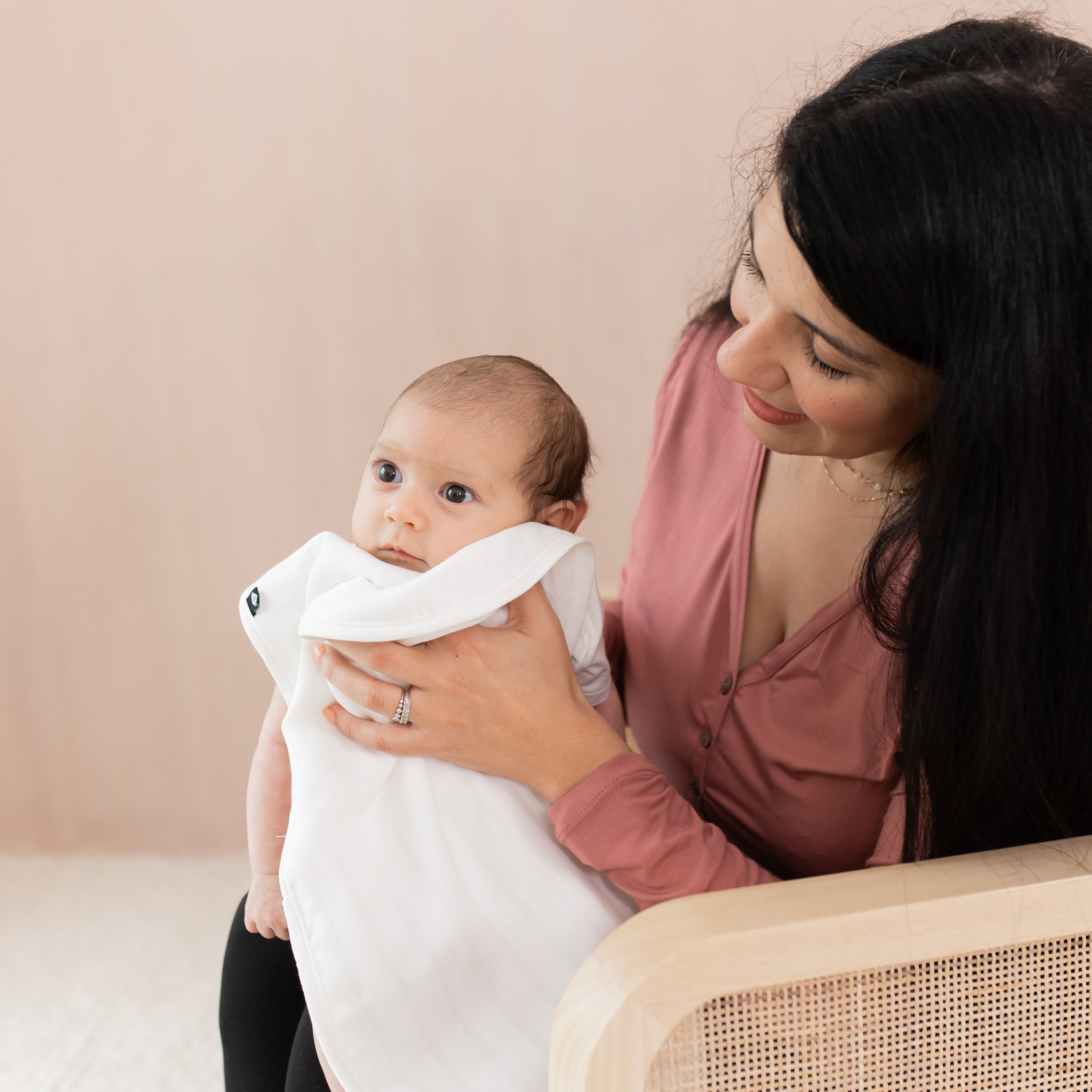 Mom holding Baby while using a white Muslin Burp Cloth