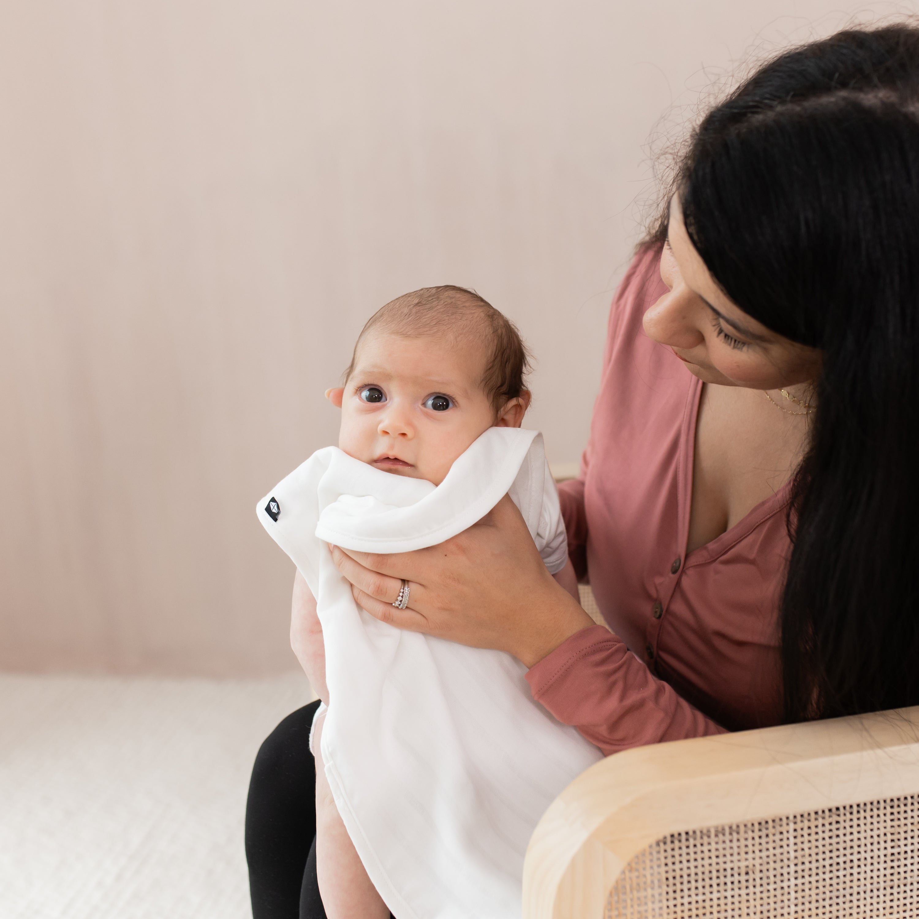 Mom holding Baby while using Cloud White Bamboo Muslin Burp Cloth