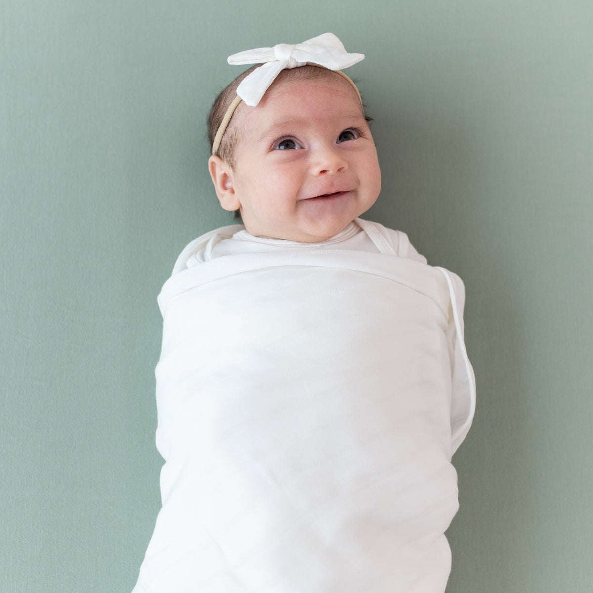 Baby wearing Medium Muslin Bow in Cloud