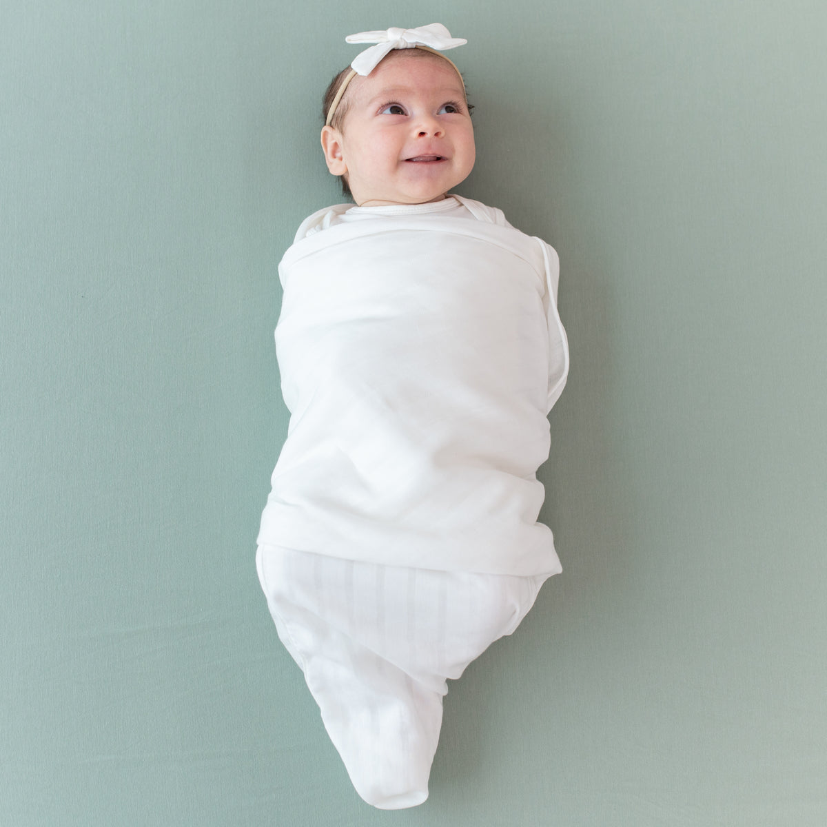 Baby swaddled in Bamboo Muslin Swaddle Blanket in Cloud
