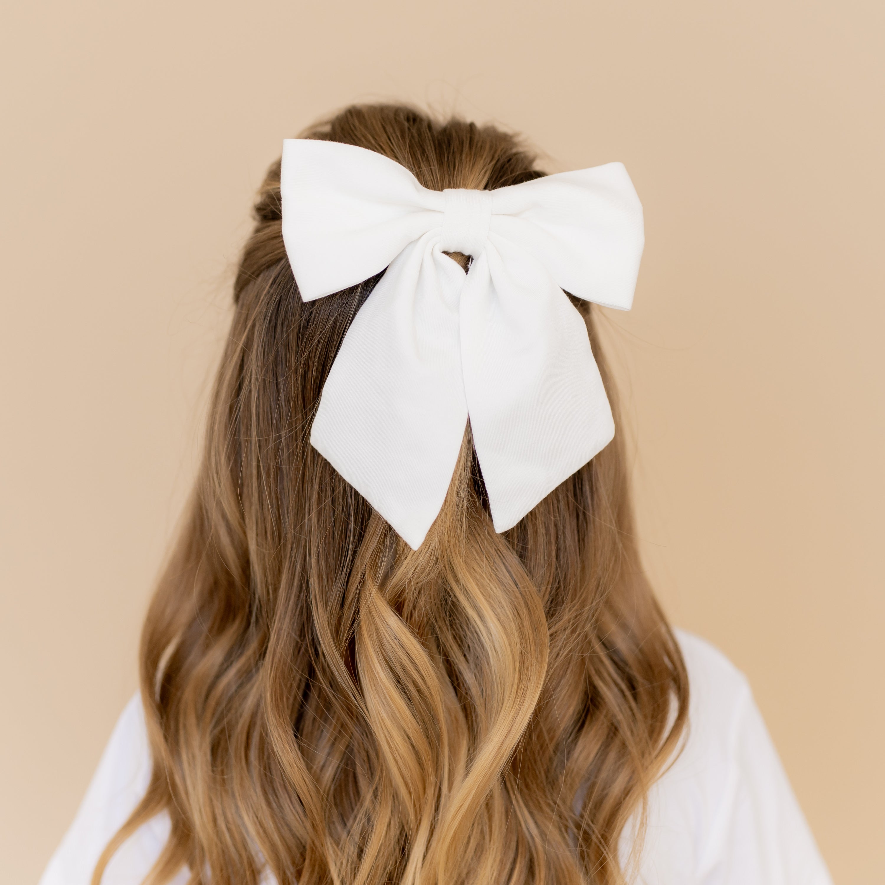 Large Alligator Clip Bow in Cloud shown in a young girls hair