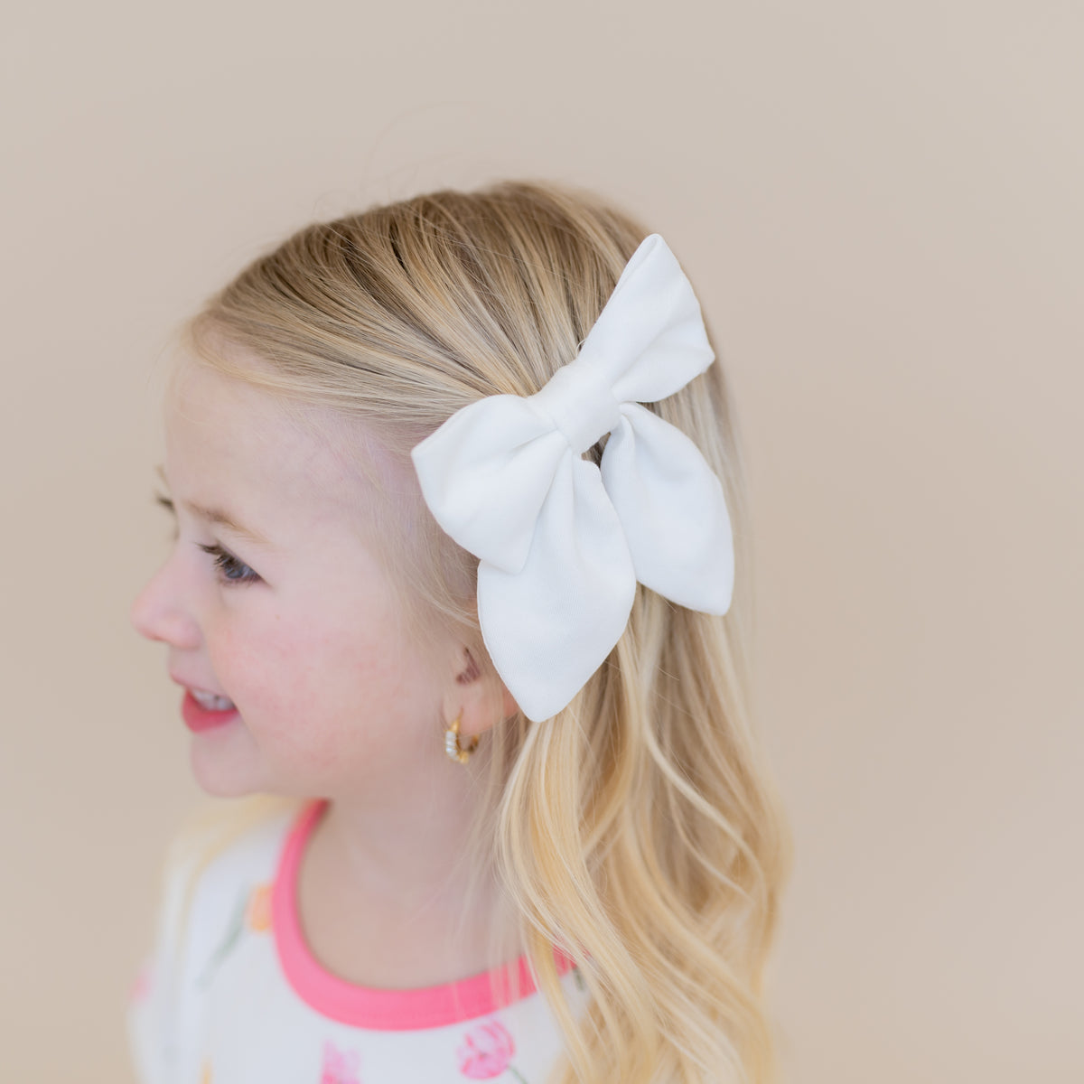 Medium Alligator Clip Bow in Cloud shown in a young girls hair