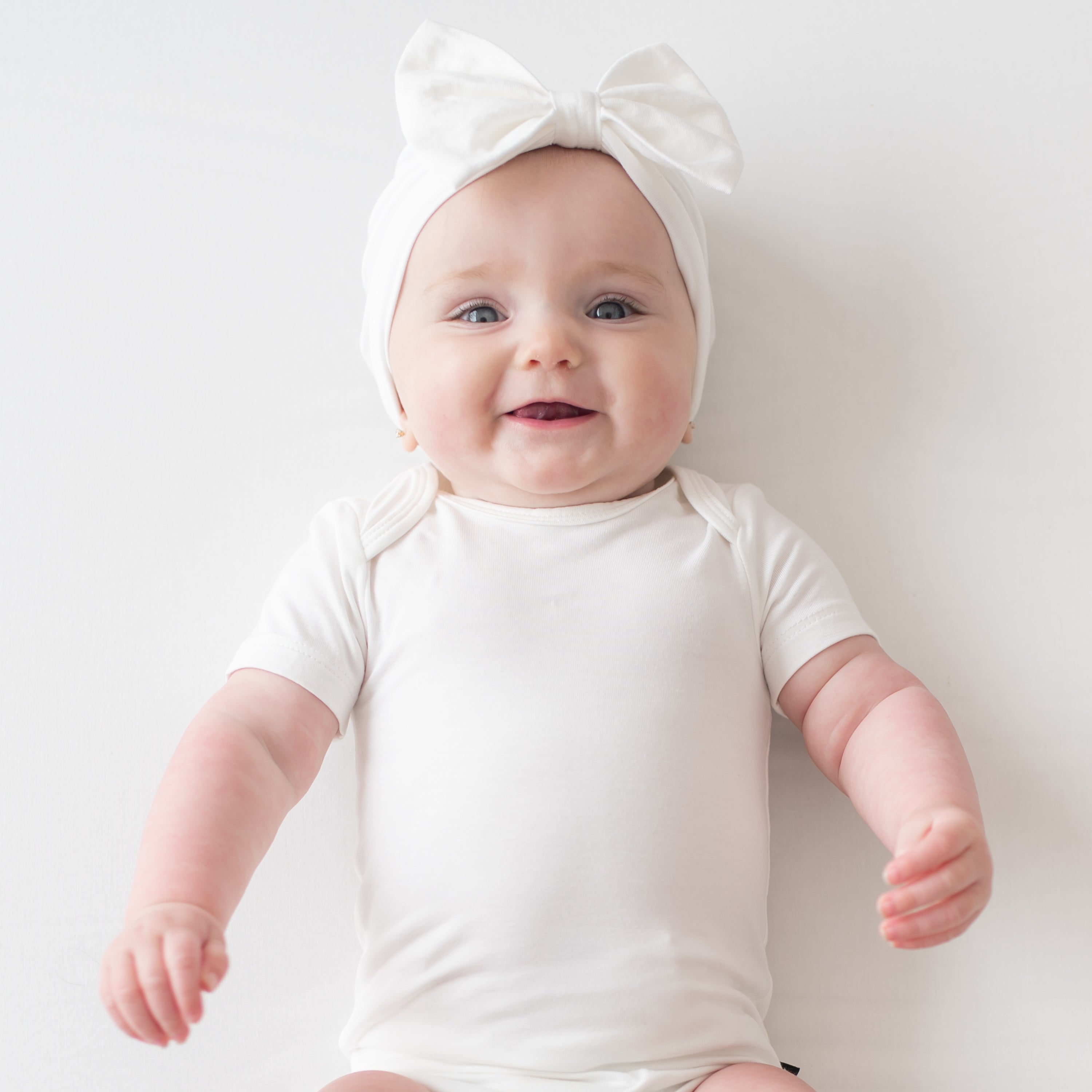 Baby wearing Bow Headband in Cloud