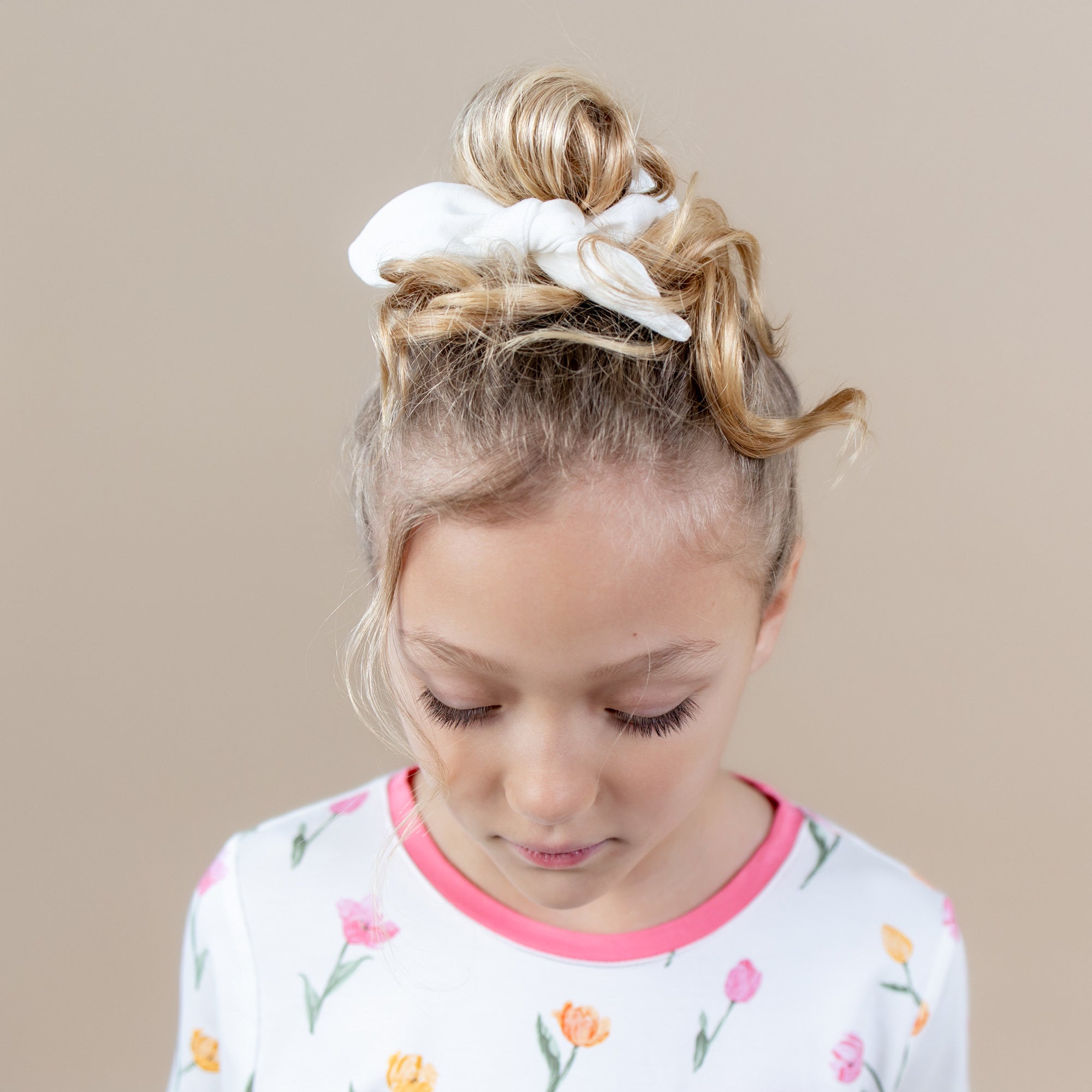 Scrunchie in Cloud shown in a young girls hair