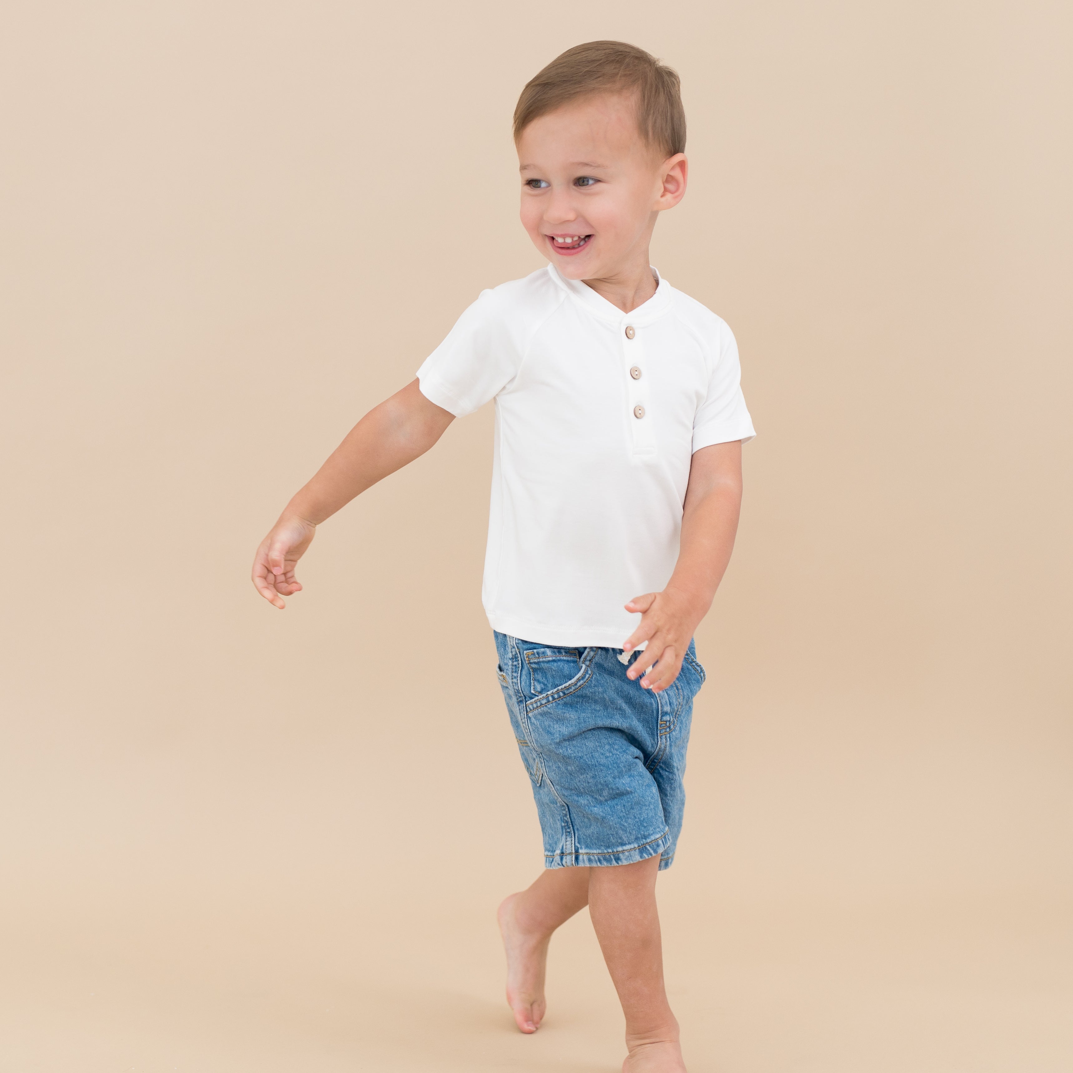 Toddler smiling in Short Sleeve Toddler Henley Tee in Cloud