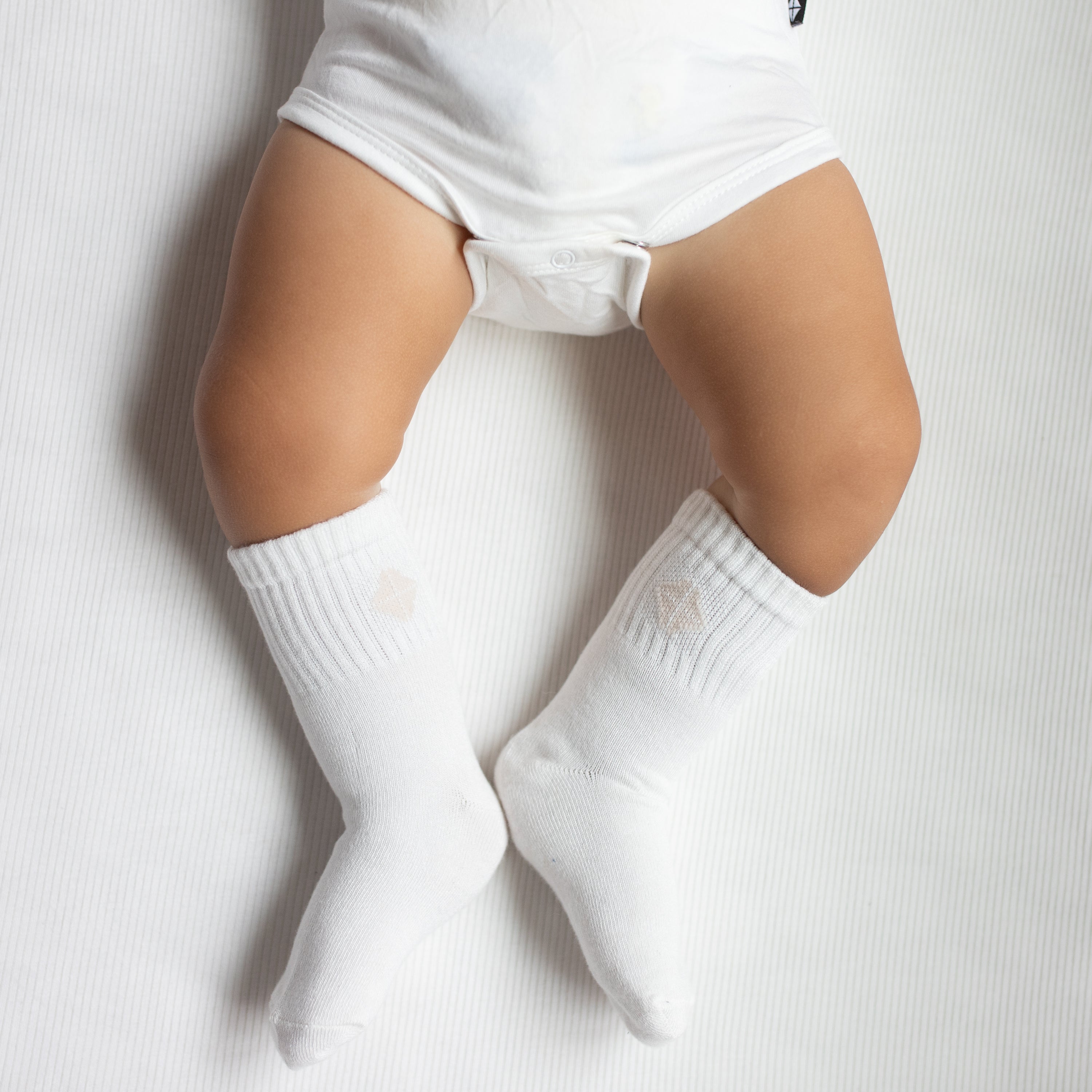 Crew Socks in Cloud shown on an infant model