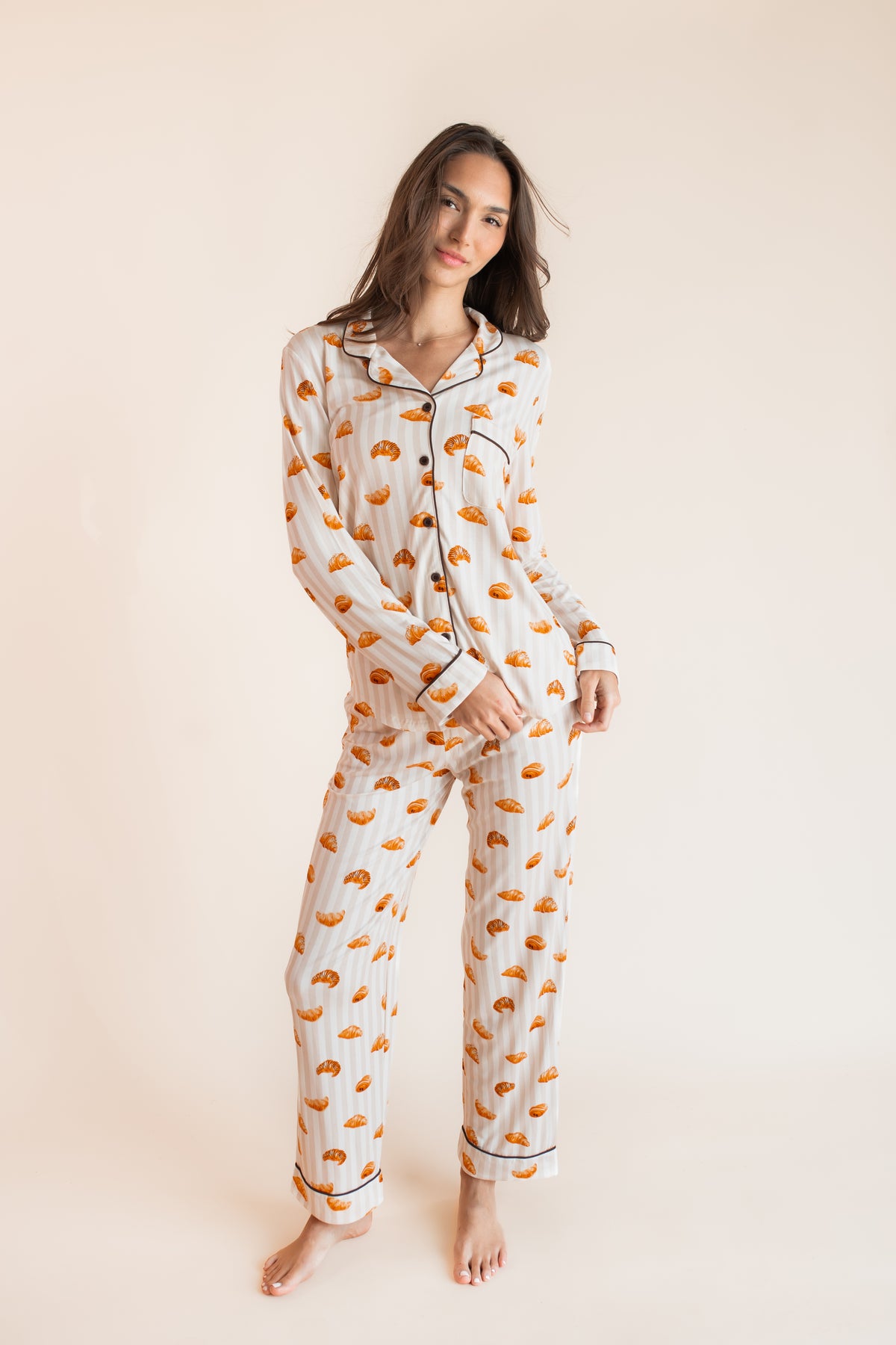 Model wearing Long-Sleeved Women's Pajama Set with Croissant print on a beige background