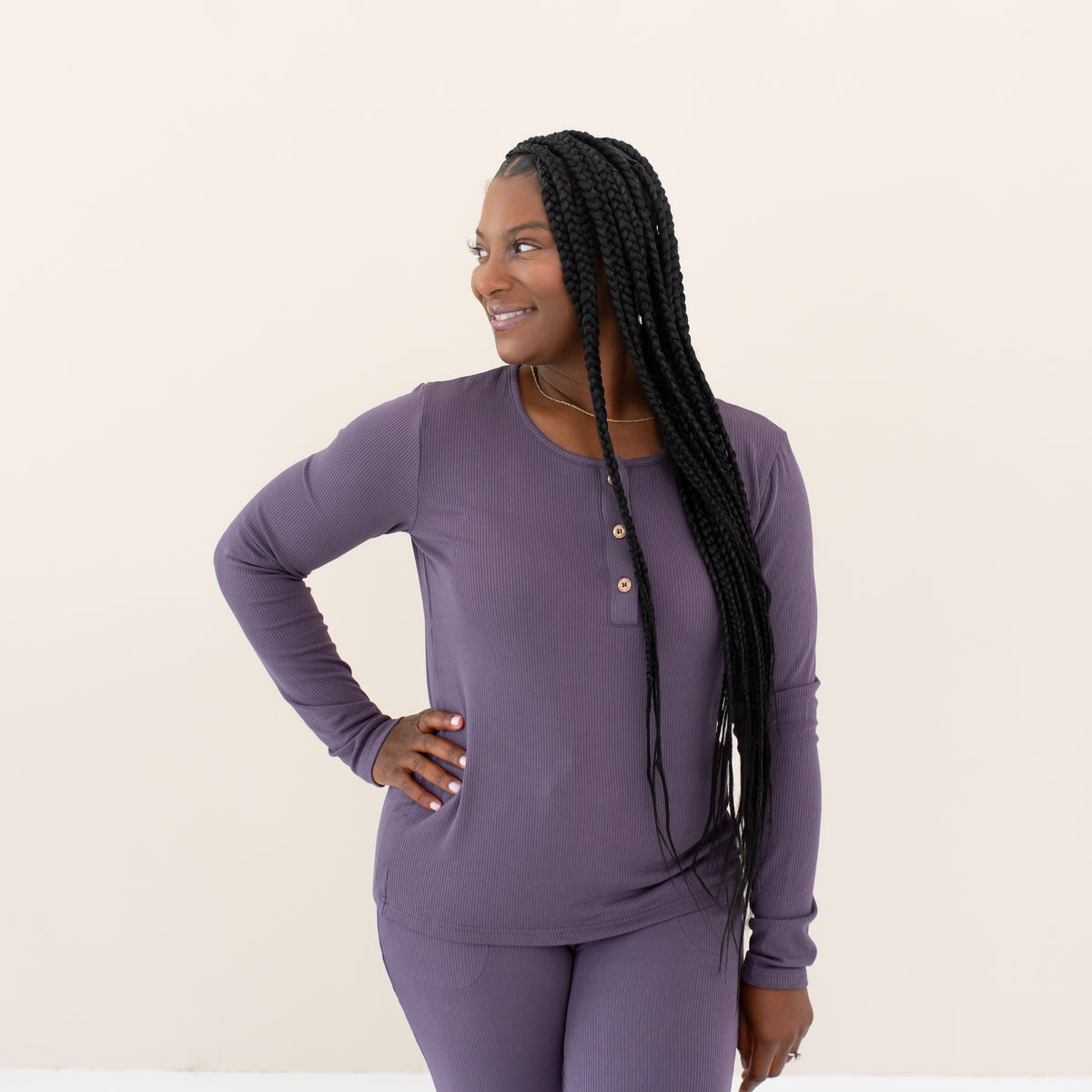 Woman modeling Women's Ribbed Henley Top in Currant looking off to the side