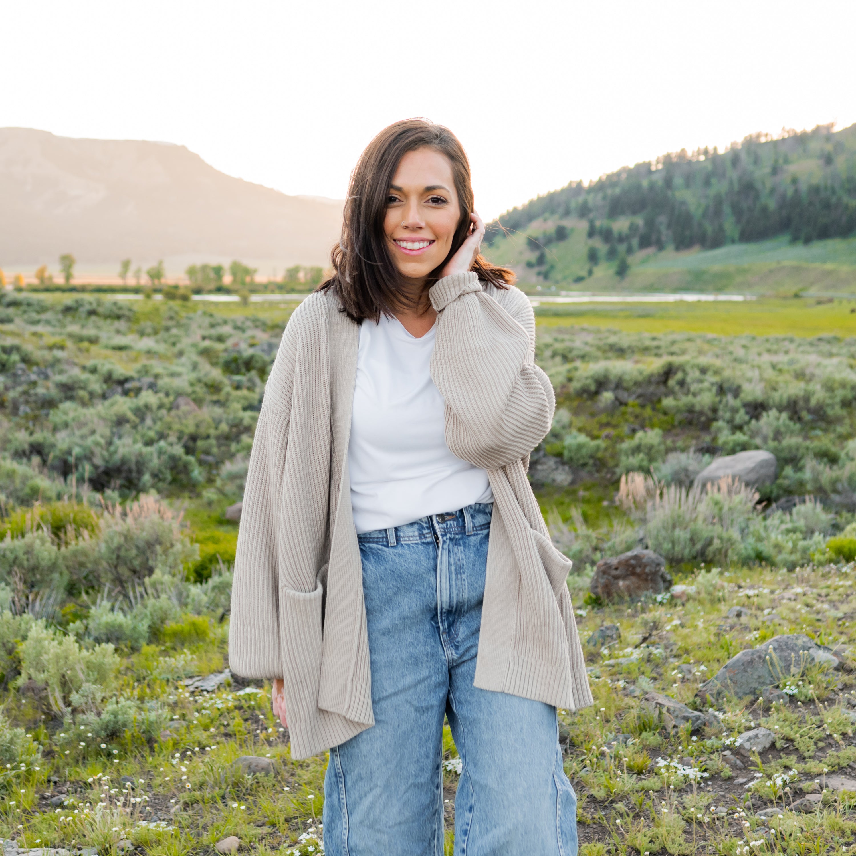 Woman wearing Chunky Knit Women's Oversized Cardigan in Oat in Yellowstone National park