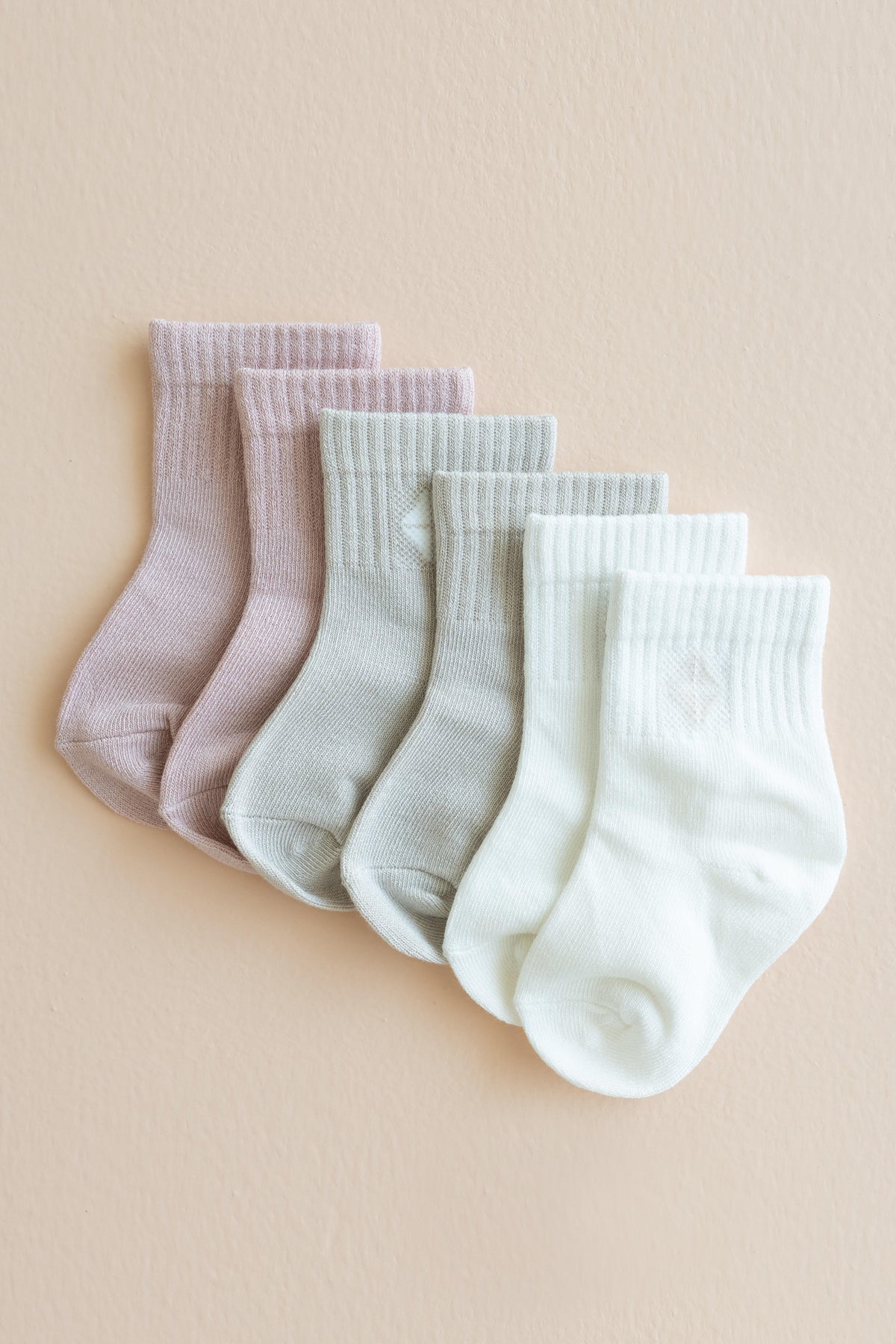 Flat lay of the Crew Socks Combo 3-Pack in Pastel shown in the colors Blush, Oat and Cloud