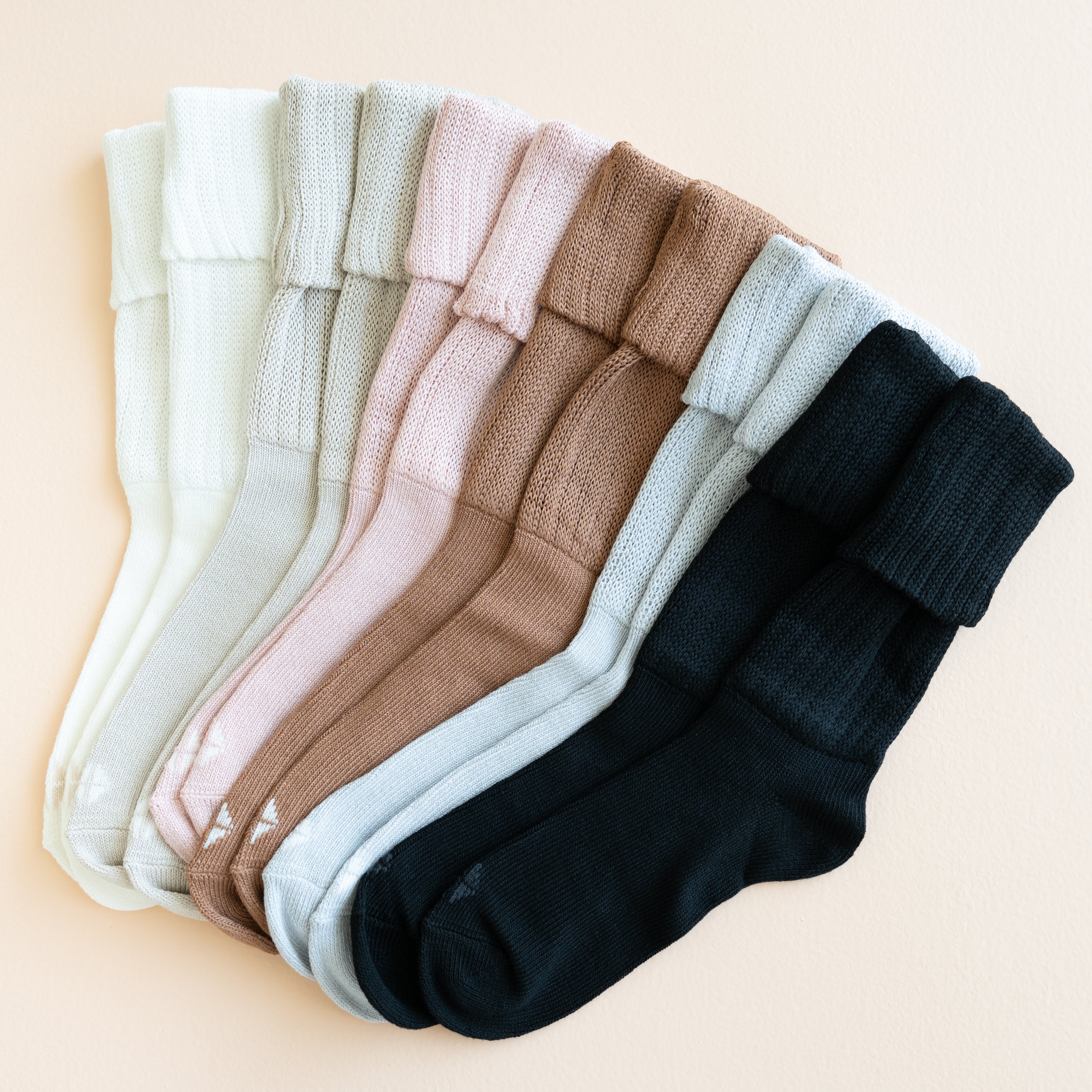 Flat lay in Adult Scrunch Socks shown in Cloud, Oat, Blush, Latte, Storm and Midnight