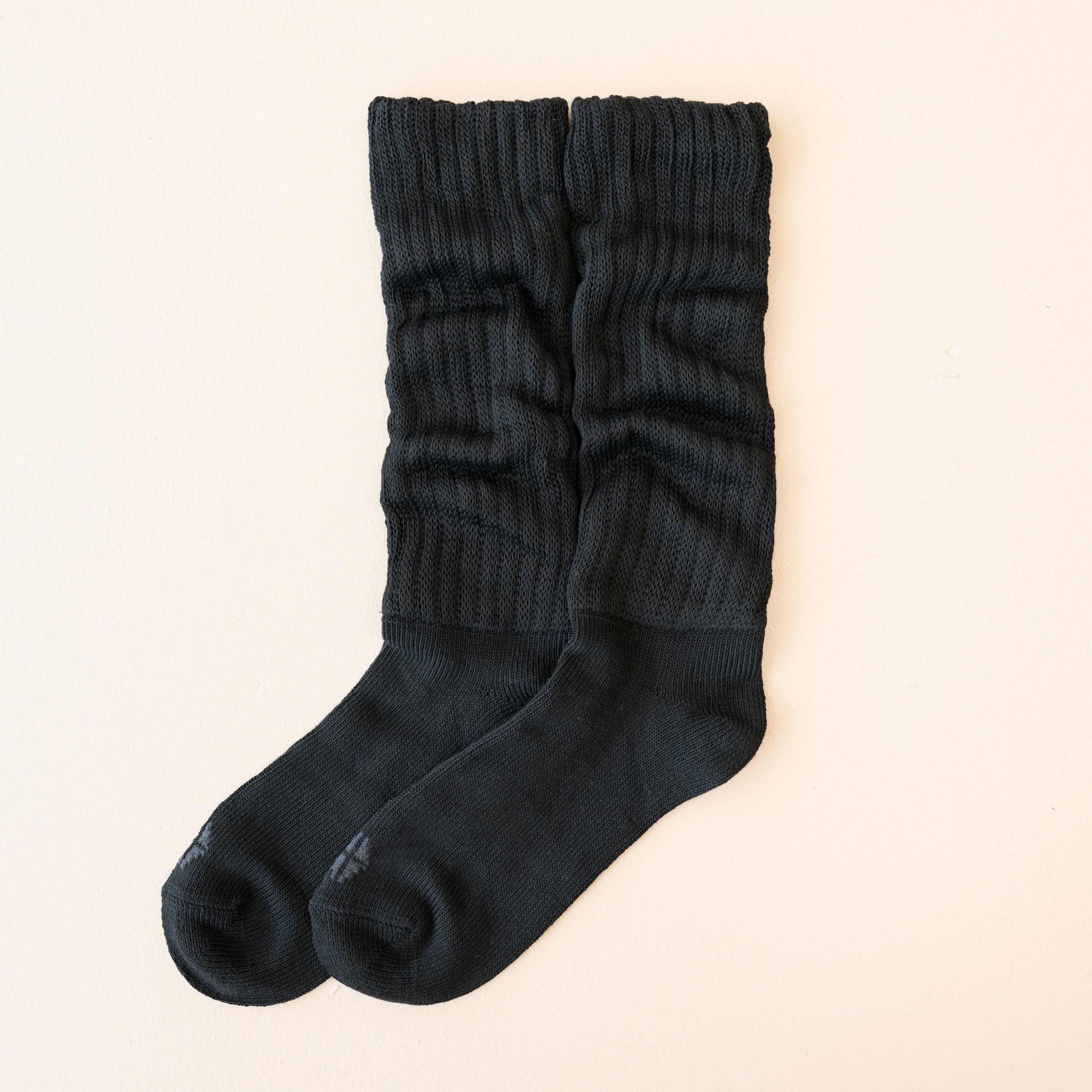 Adult Scrunch Socks in Midnight shown out of package laying side by side on a light neutral background