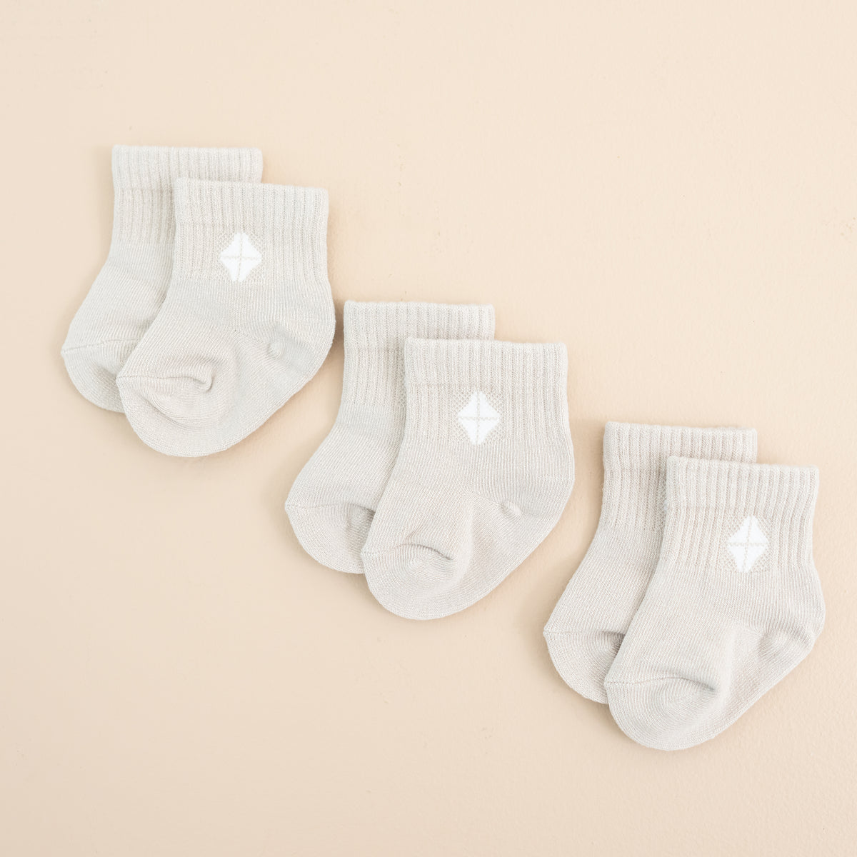 Photo of the Crew Socks Combo 3-Pack in Oat laid out side by side on a light neutral background