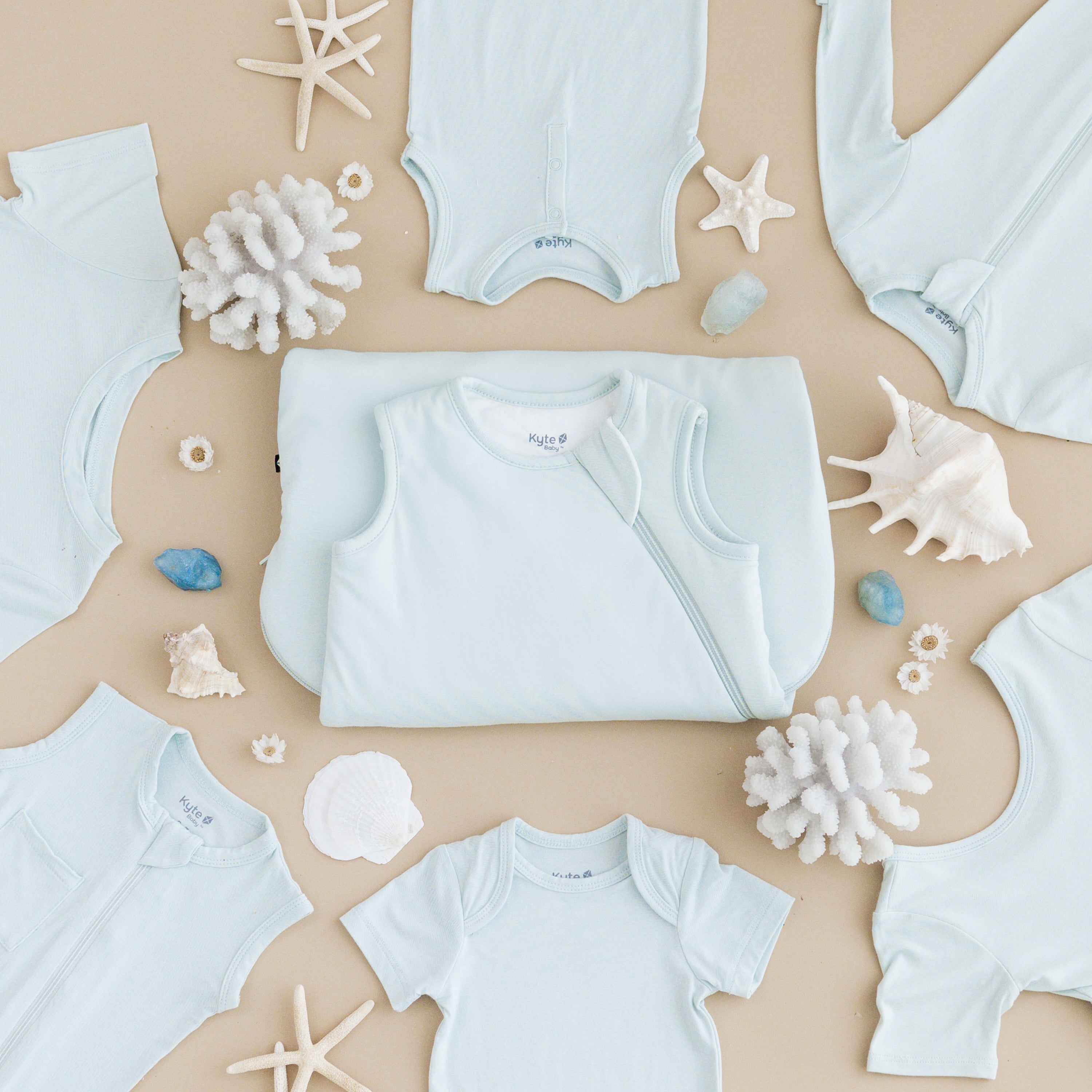 Flat lay of Dew collection with sea shell accessories