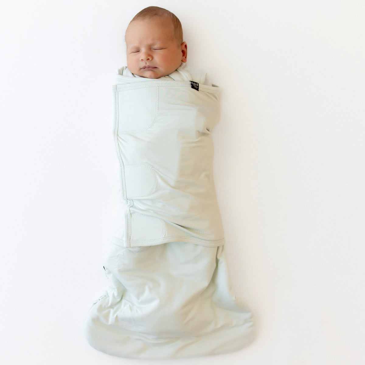 Baby swaddled in the Sleep Bag Swaddler in Dew 1.0 TOG
