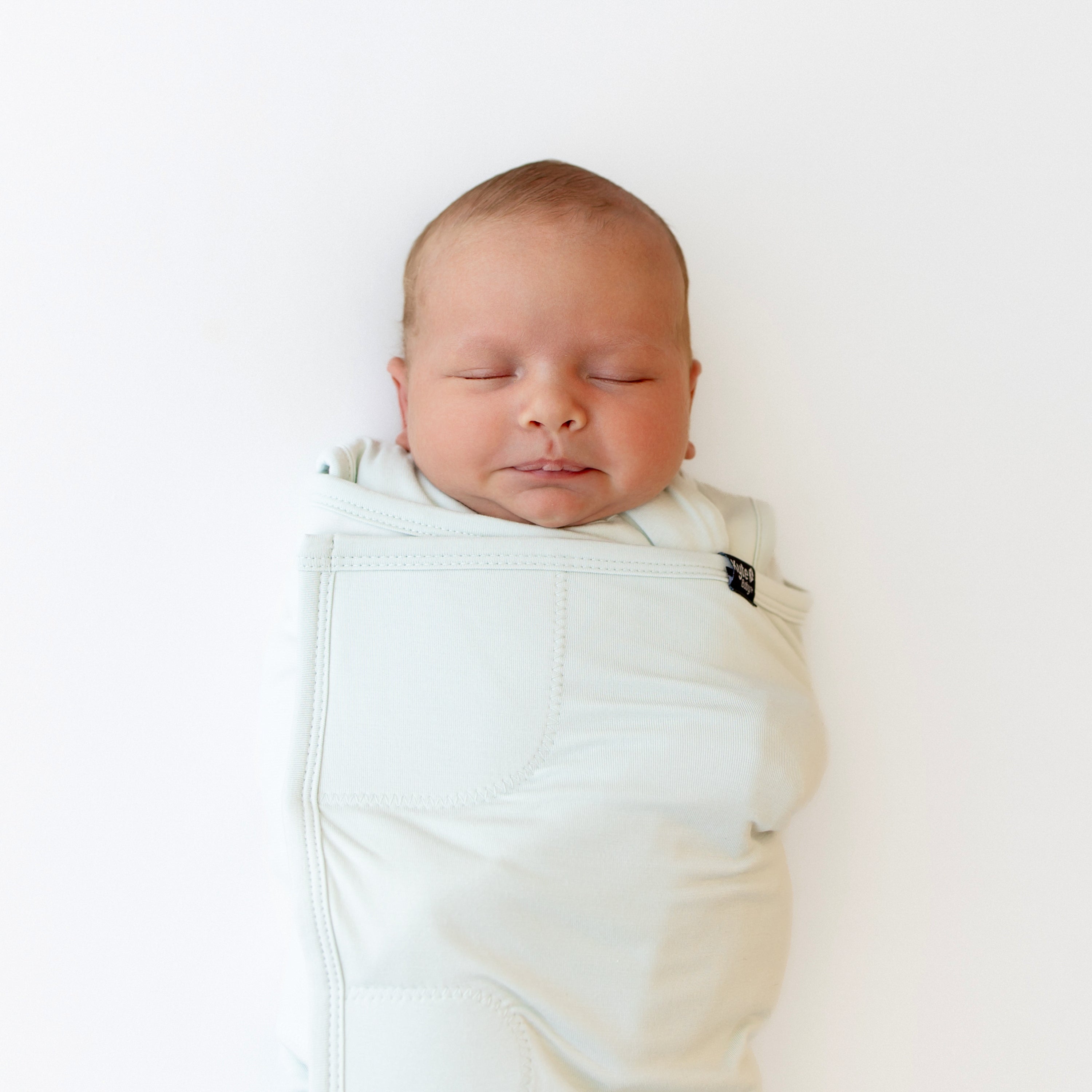 Newborn swaddled in the bamboo Sleep Bag Swaddler in Dew 1.0