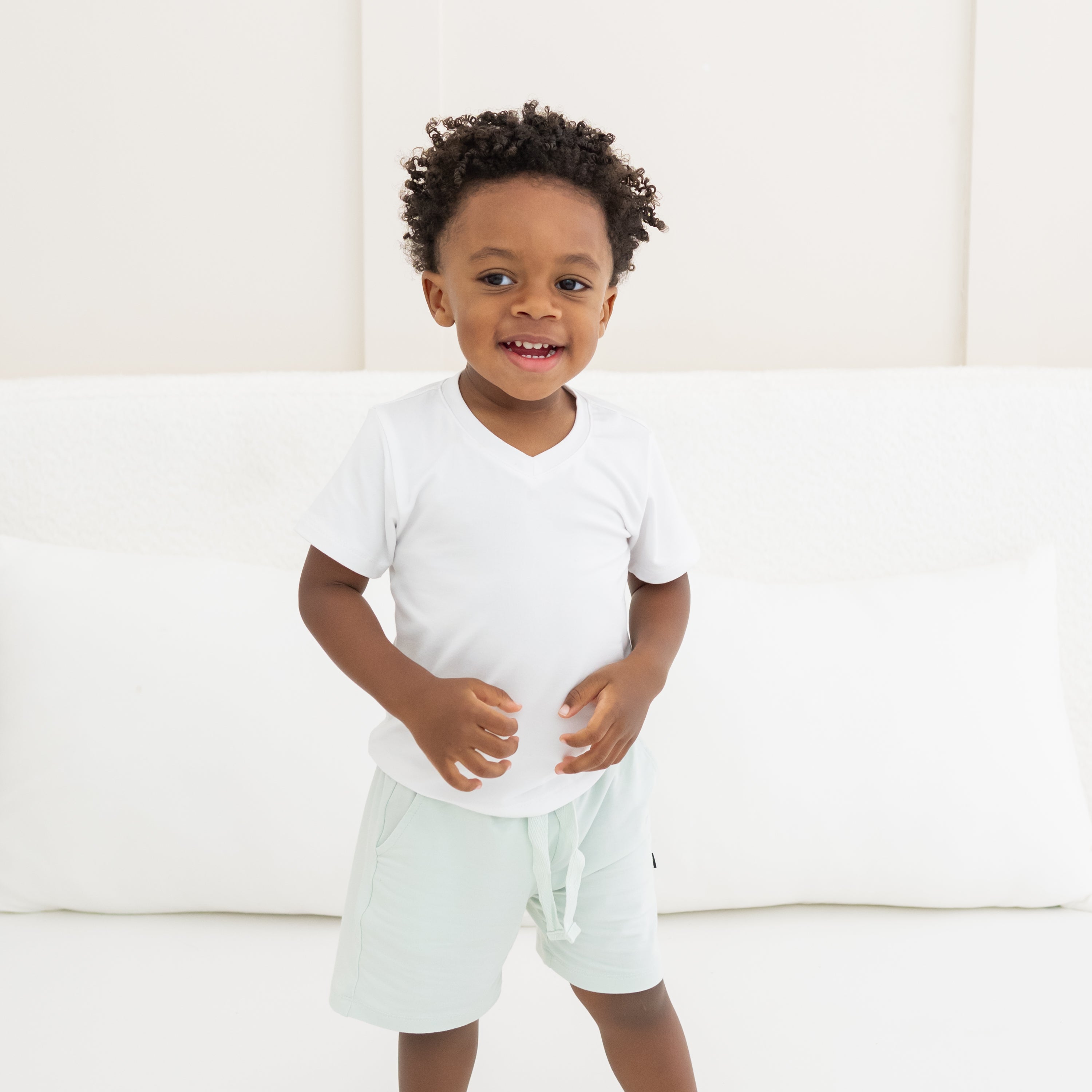 Child wearing the Drawstring Short in Dew paired with a Toddler V-Neck in Snow