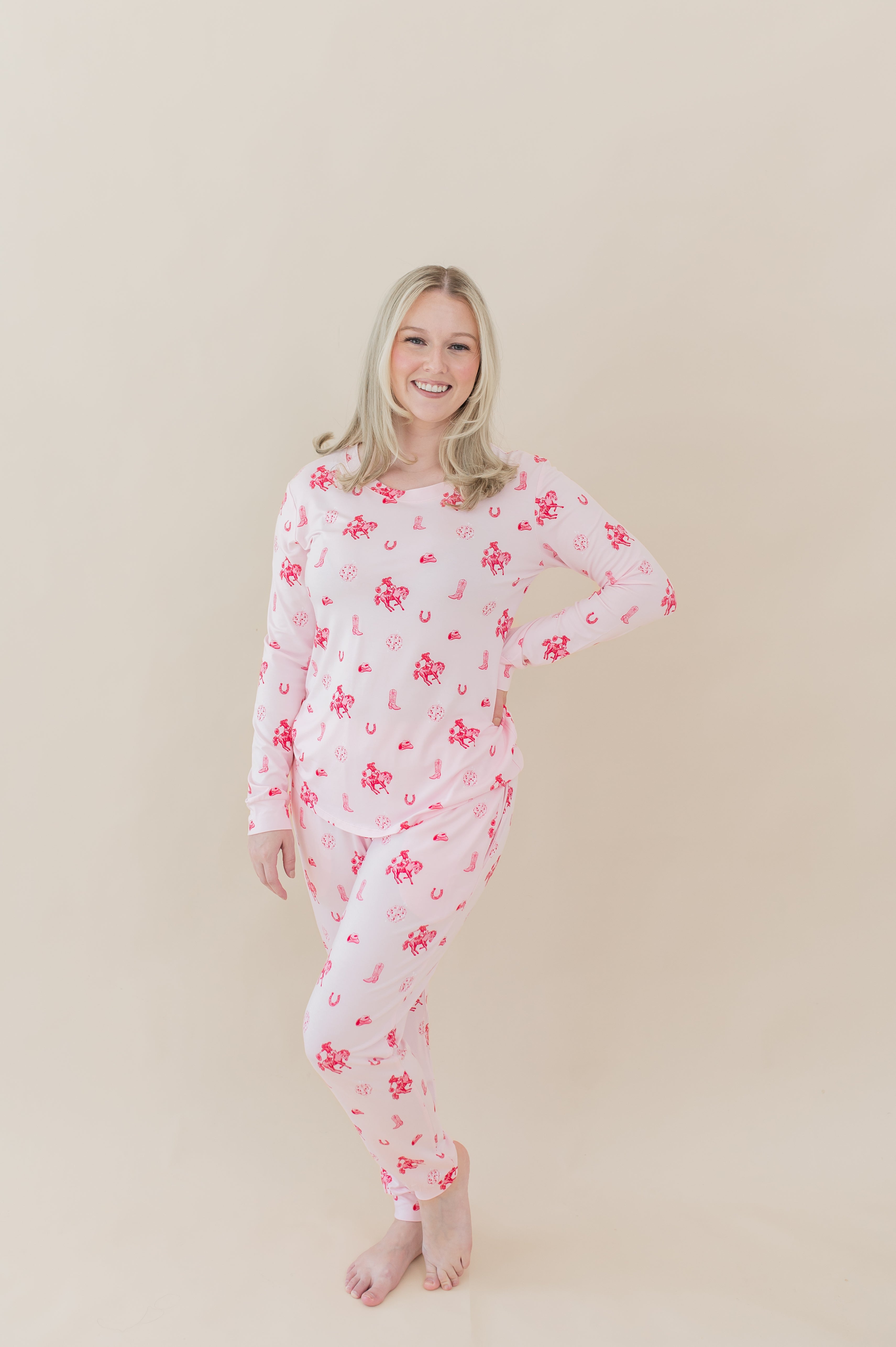 Female modeling the Women's Jogger Pajama Set in Disco Cowgirl with one hand on her hip in front of a light taupe backdrop