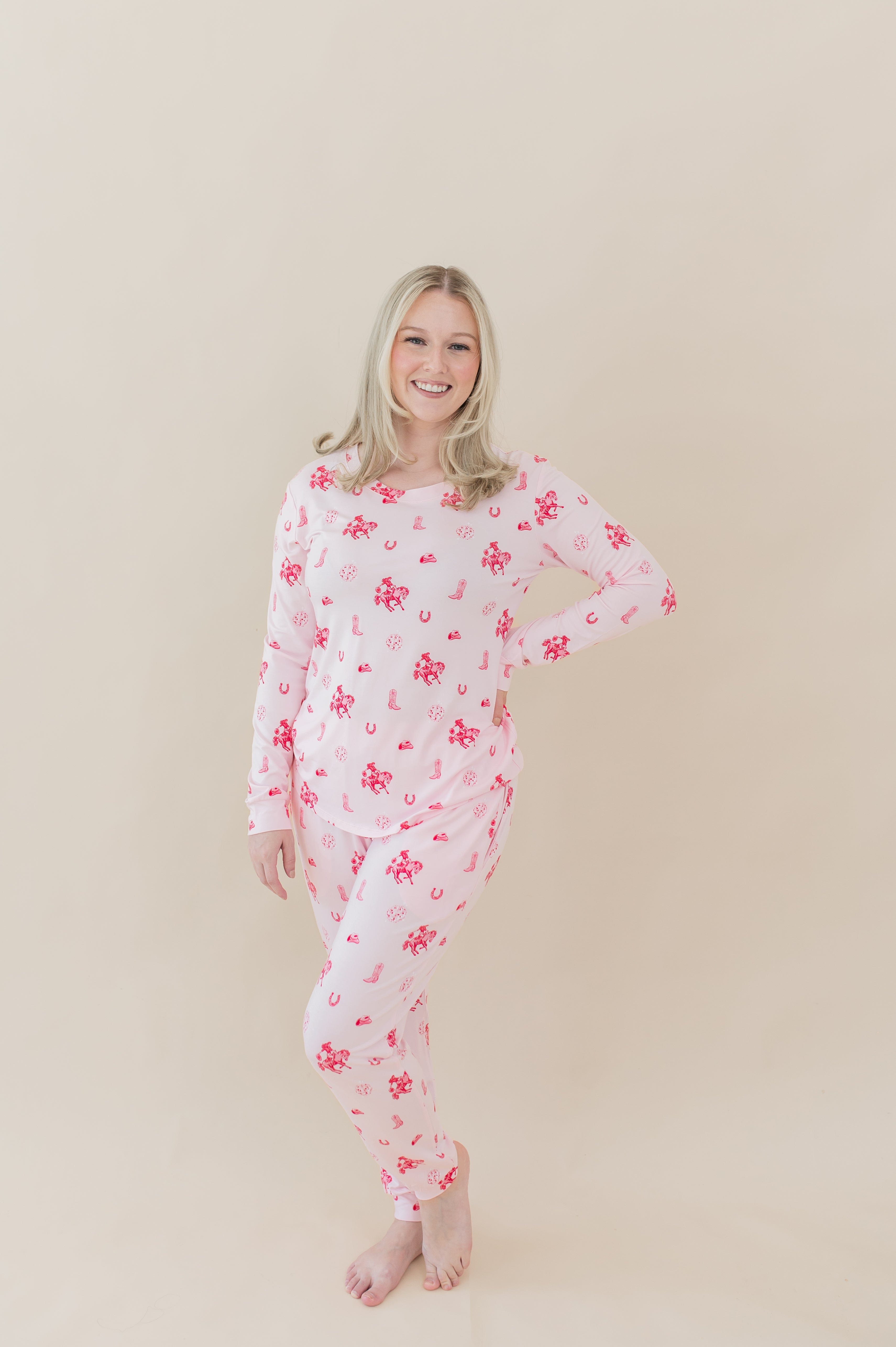 Female modeling the Women's Jogger Pajama Set in Disco Cowgirl with one hand on her hip in front of a light taupe backdrop