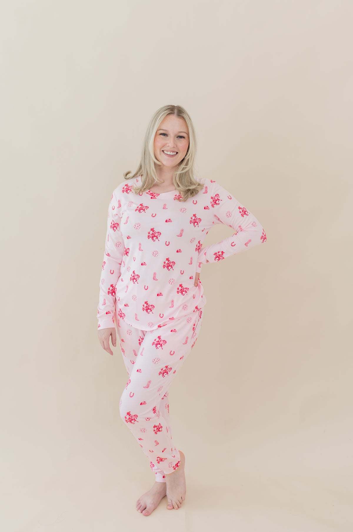 Female modeling the Women's Jogger Pajama Set in Disco Cowgirl with one hand on her hip in front of a light taupe backdrop