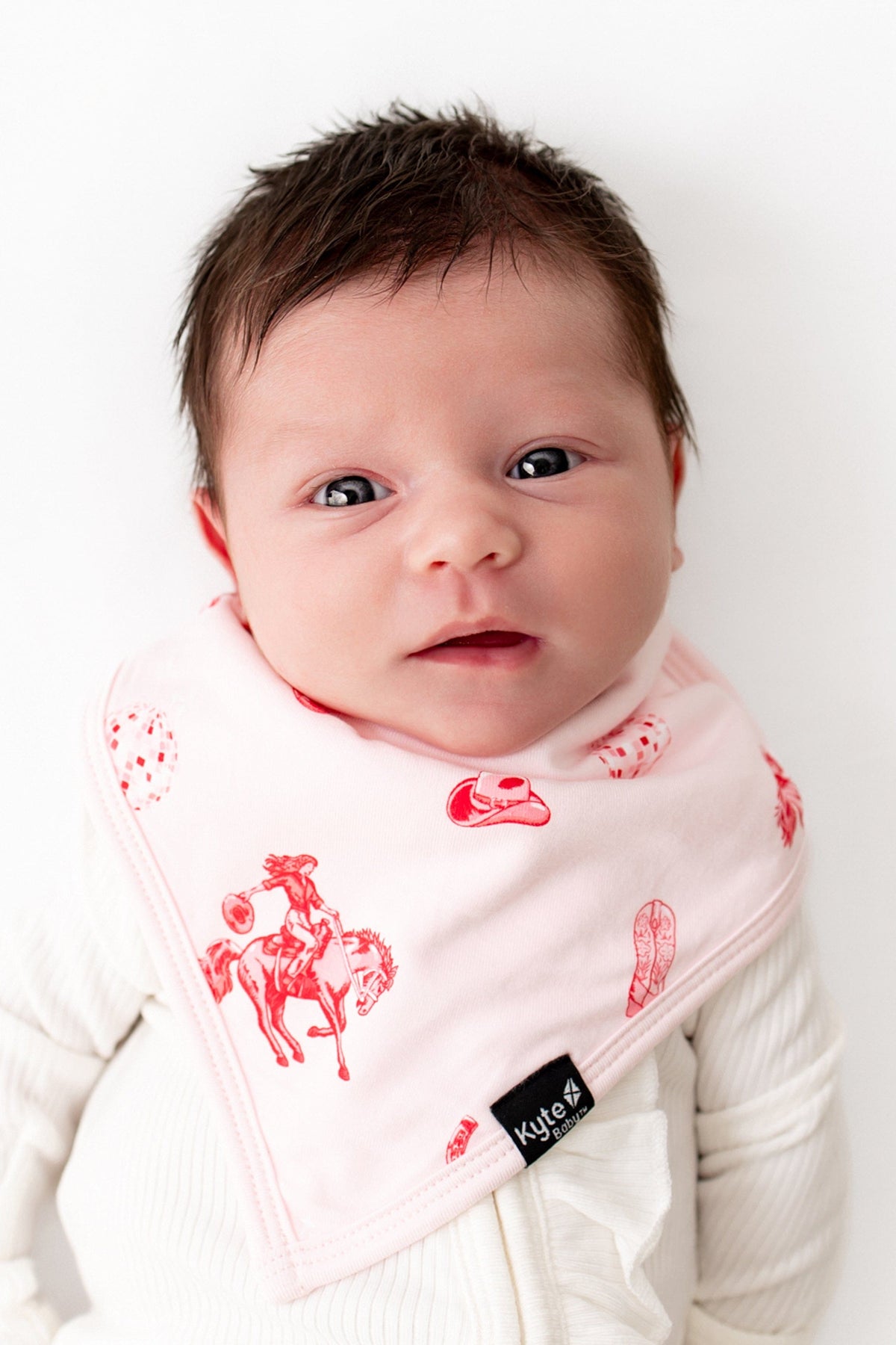 Close up of newborn wearing the Bib in Disco Cowgirl