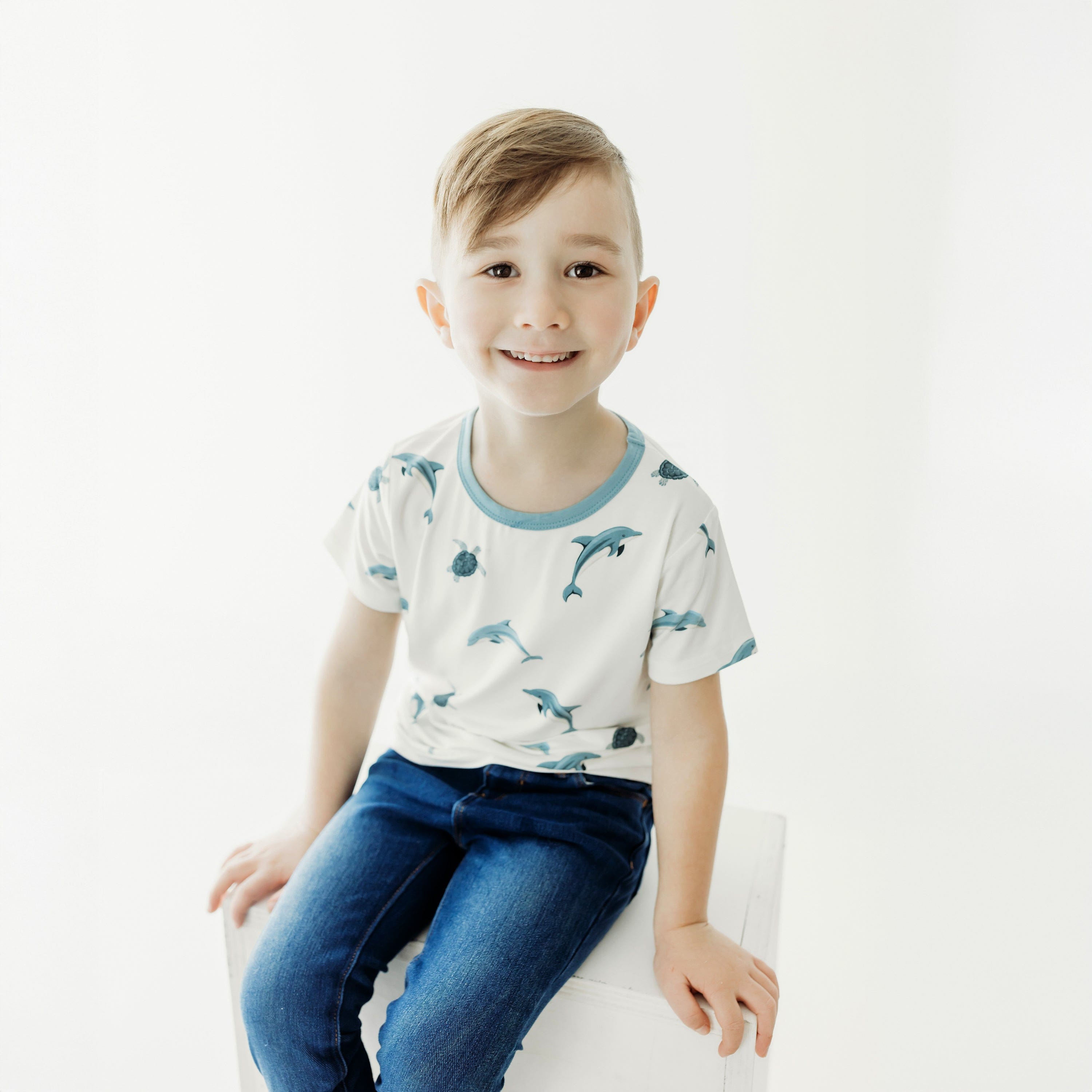 child wearing basic tee in dolphin