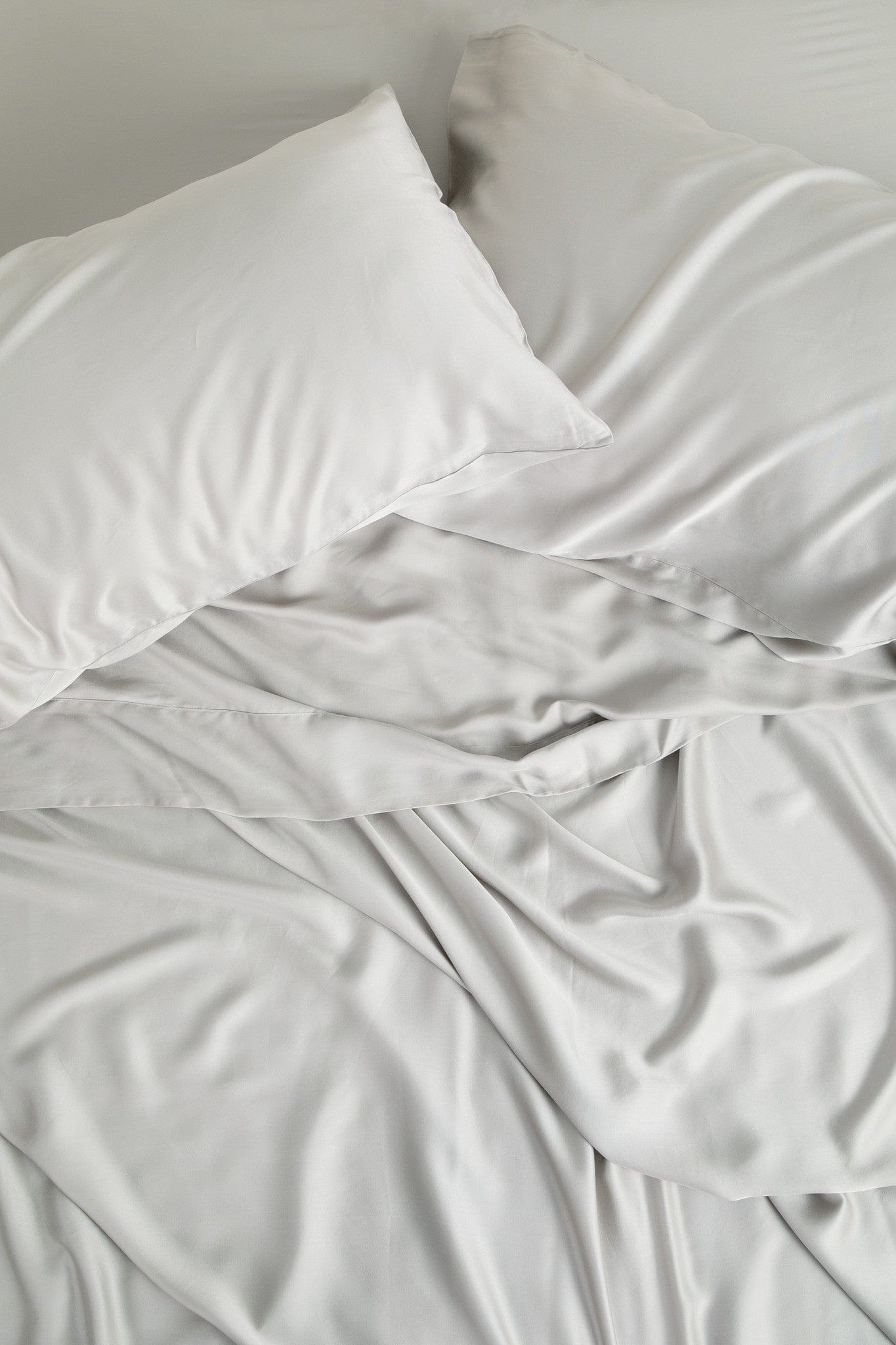 Close up of the Bamboo Sateen Sheet Set in Dove Gray shown on a bed