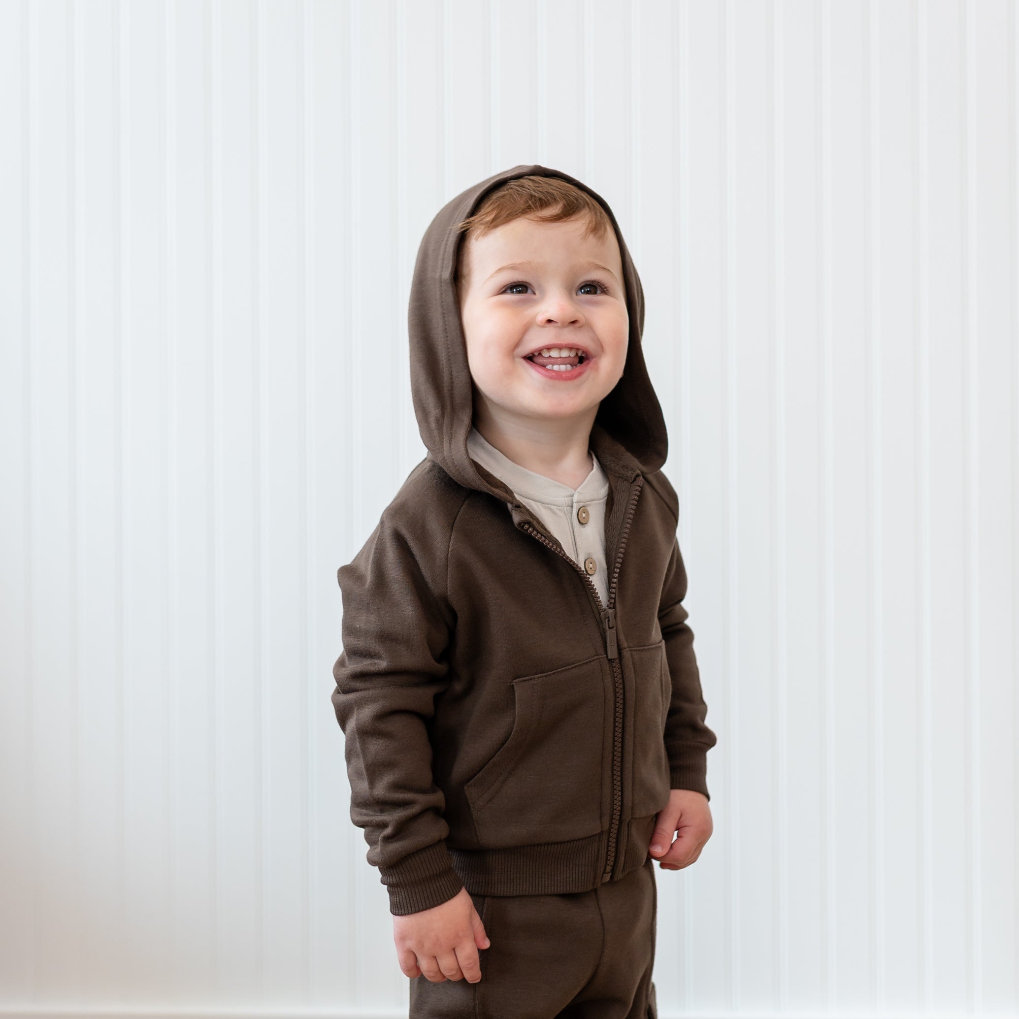 Close up of the Fleece Zip Up Hoodie in Espresso with the hood up shown on a young toddler