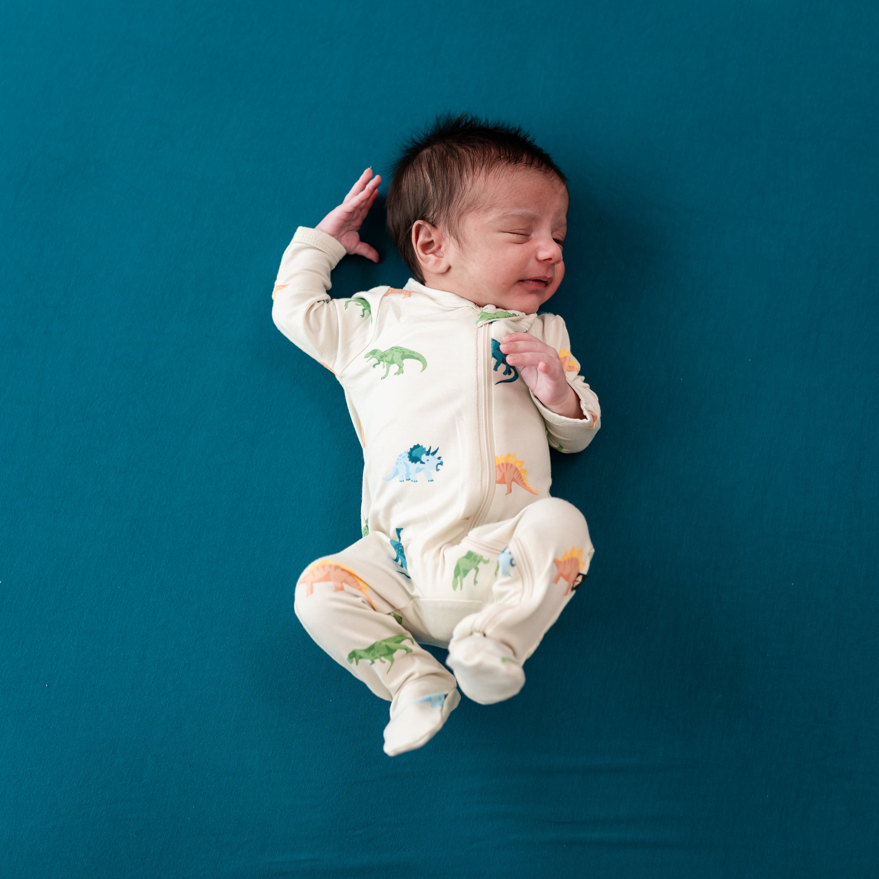 Newborn baby in Ecru Roar zippered footie