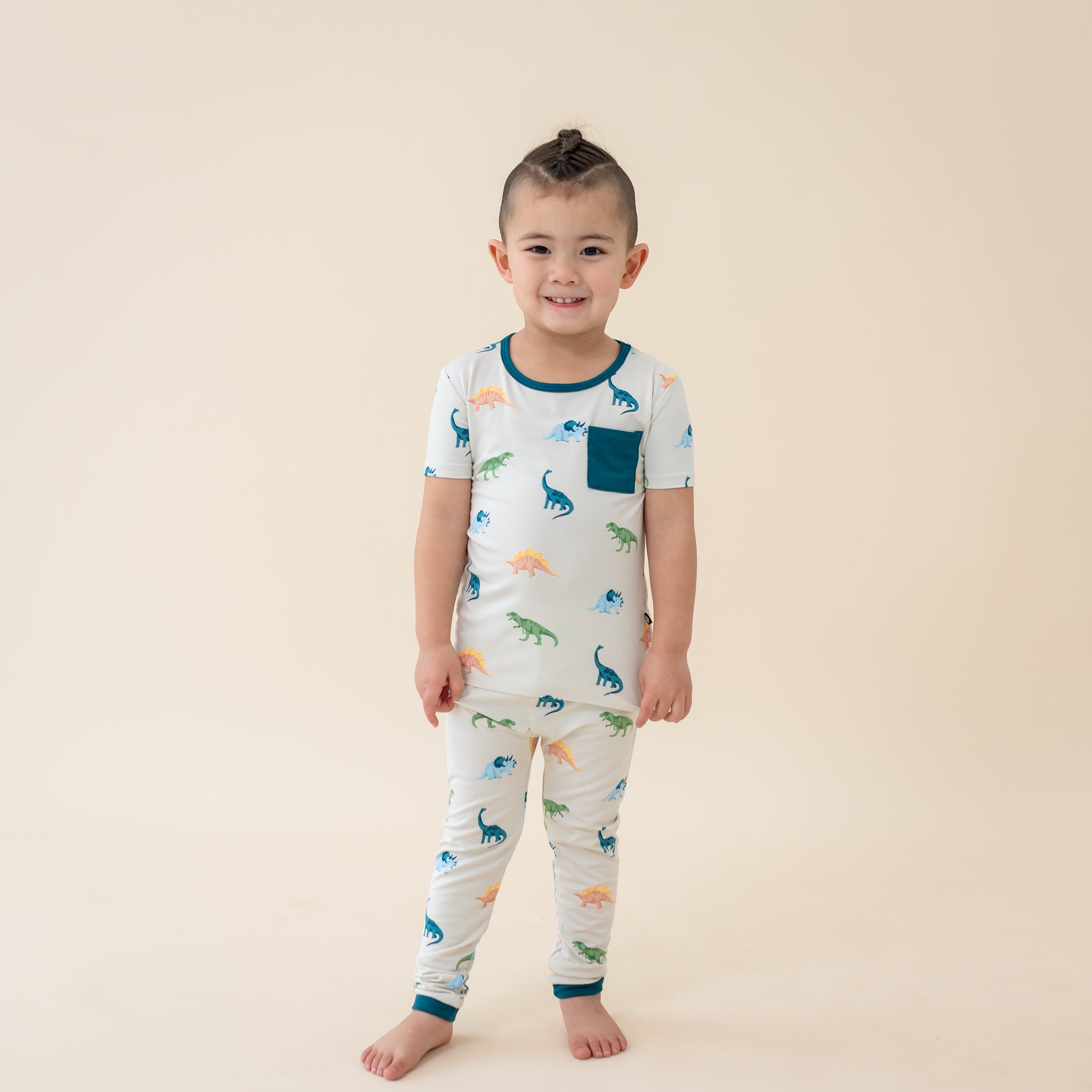 Child wearing Ecru Roar Short Sleeve with Pants Toddler Pajama Set