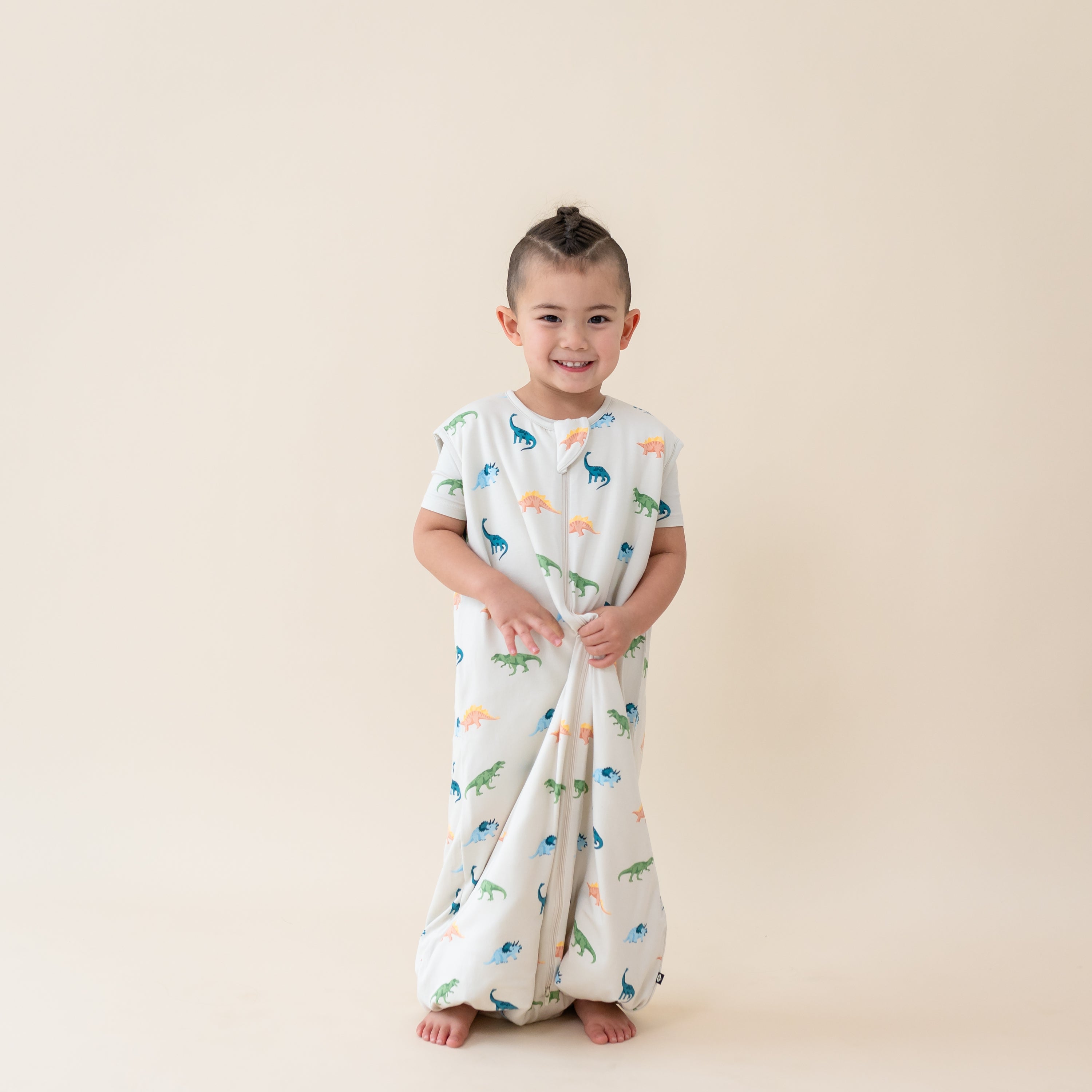 Child modeling the 1.0 TOG Sleep Bag Walker in Ecru Roar