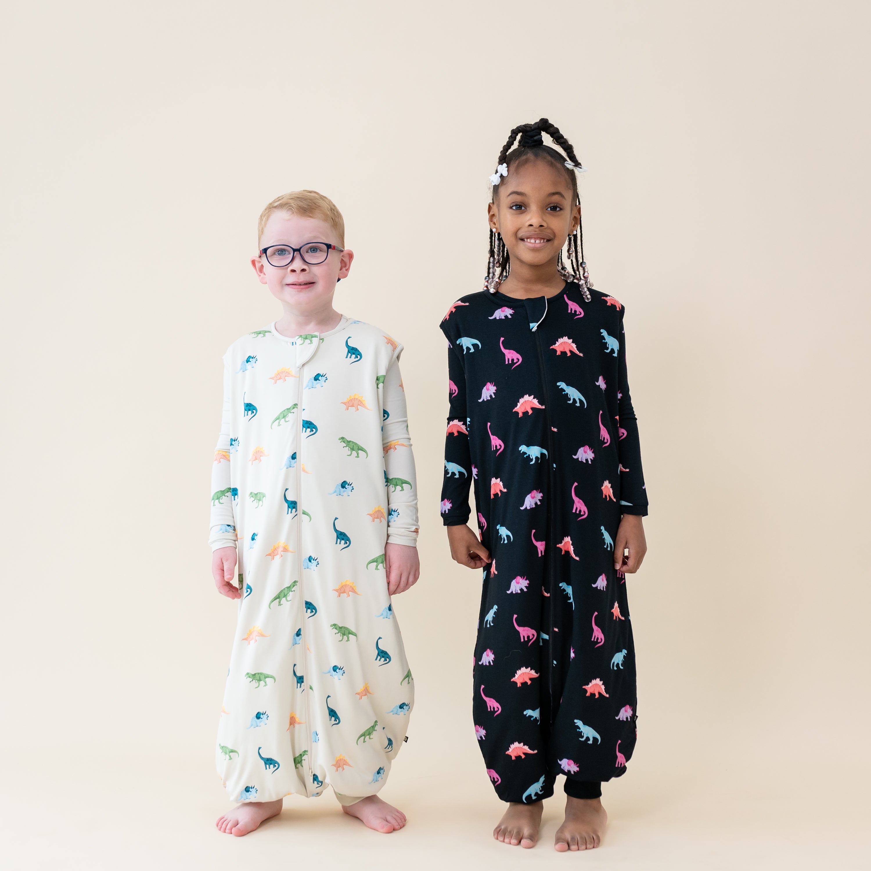 Two models wearing 1.0 TOG Sleep Bag Walkers in both Ecru and Midnight Roar