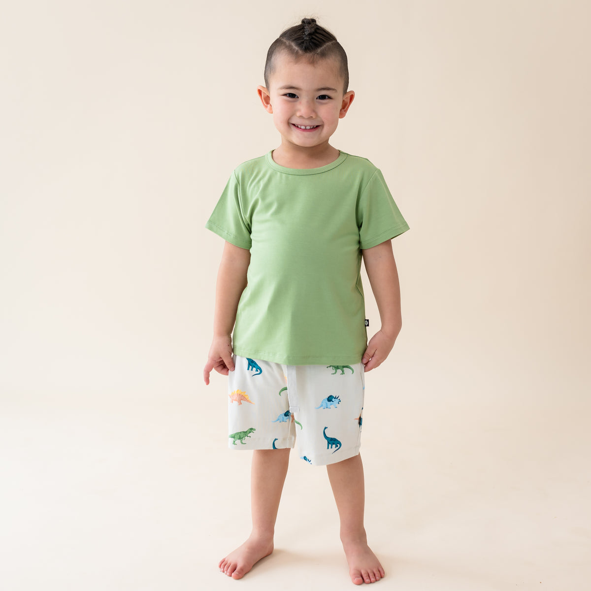 Boy modeling the toddler drawstring shorts in Ecru Roar