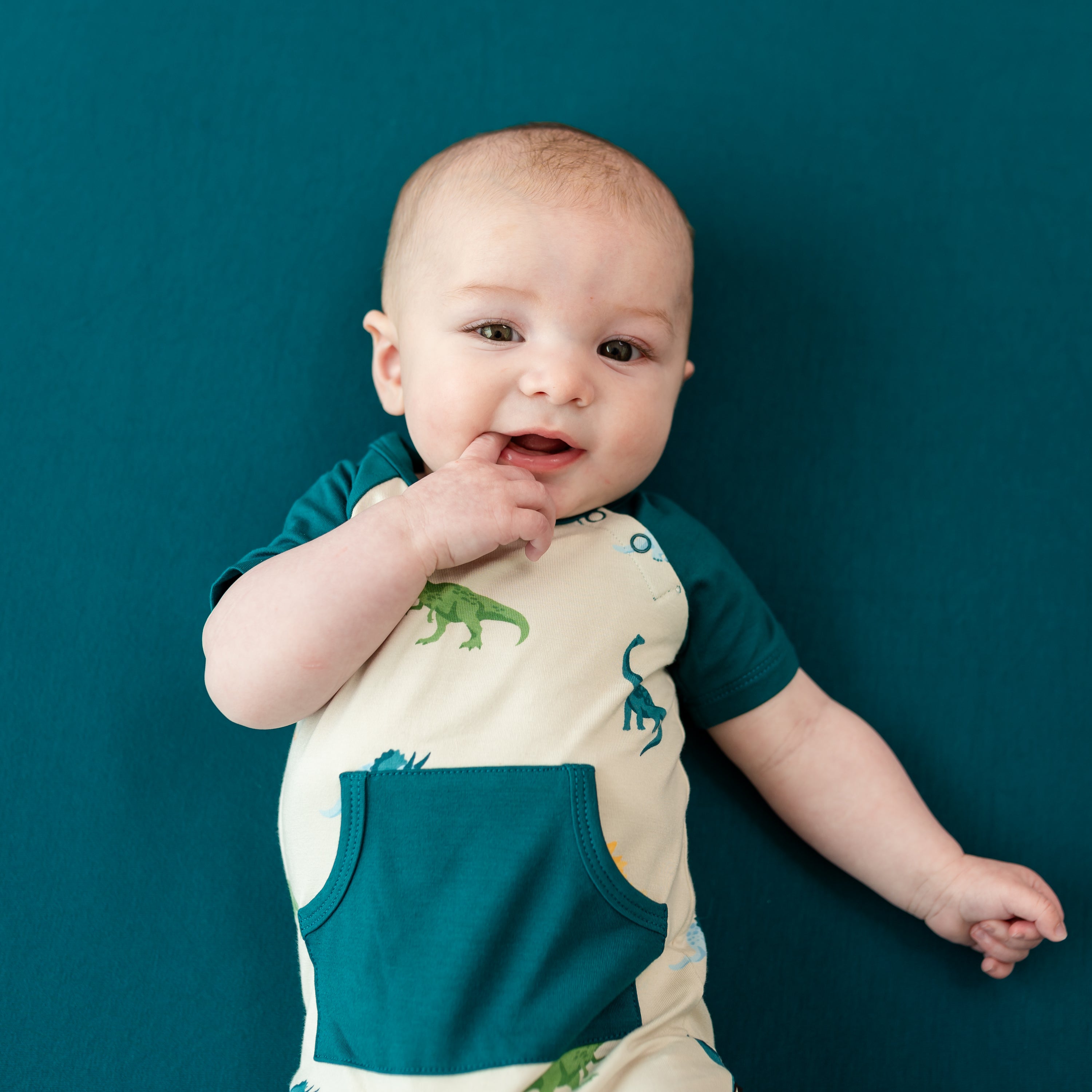 Infant modeling the Shortall in Ecru Roar