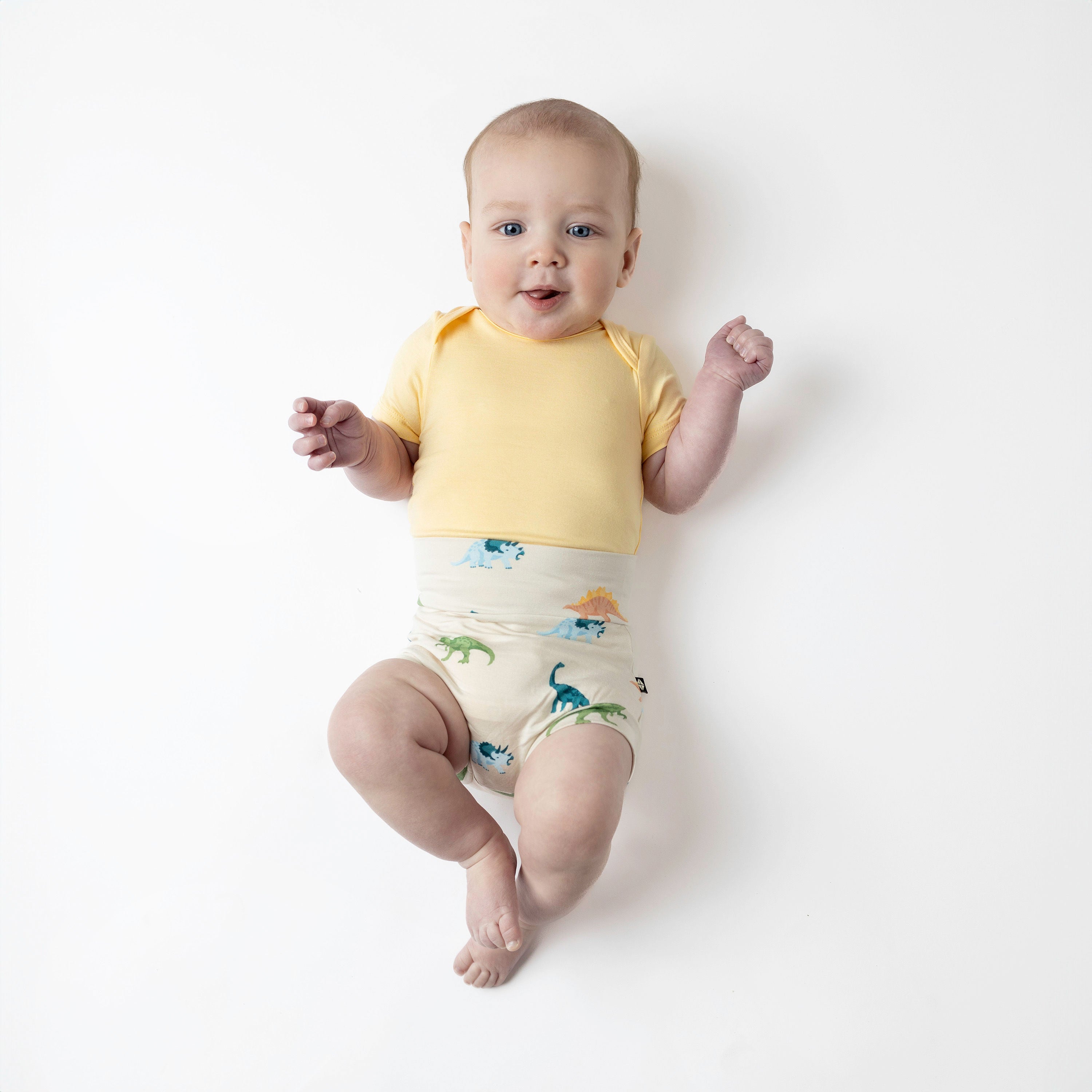 Baby modeling ecru roar bummies and lilikoi bodysuit