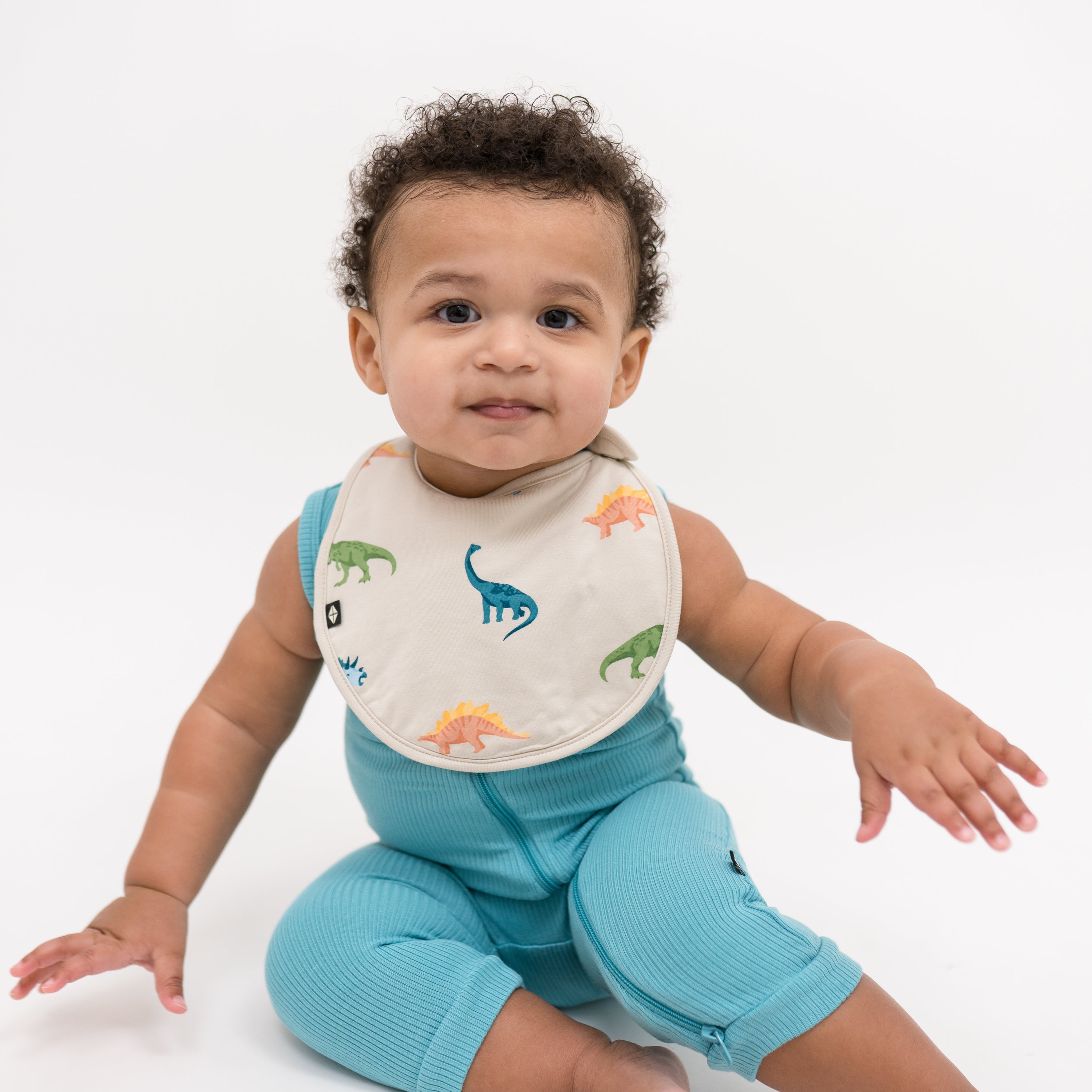 Baby in Makai Ribbed Sleeveless Romper and Ecru Roar Bib