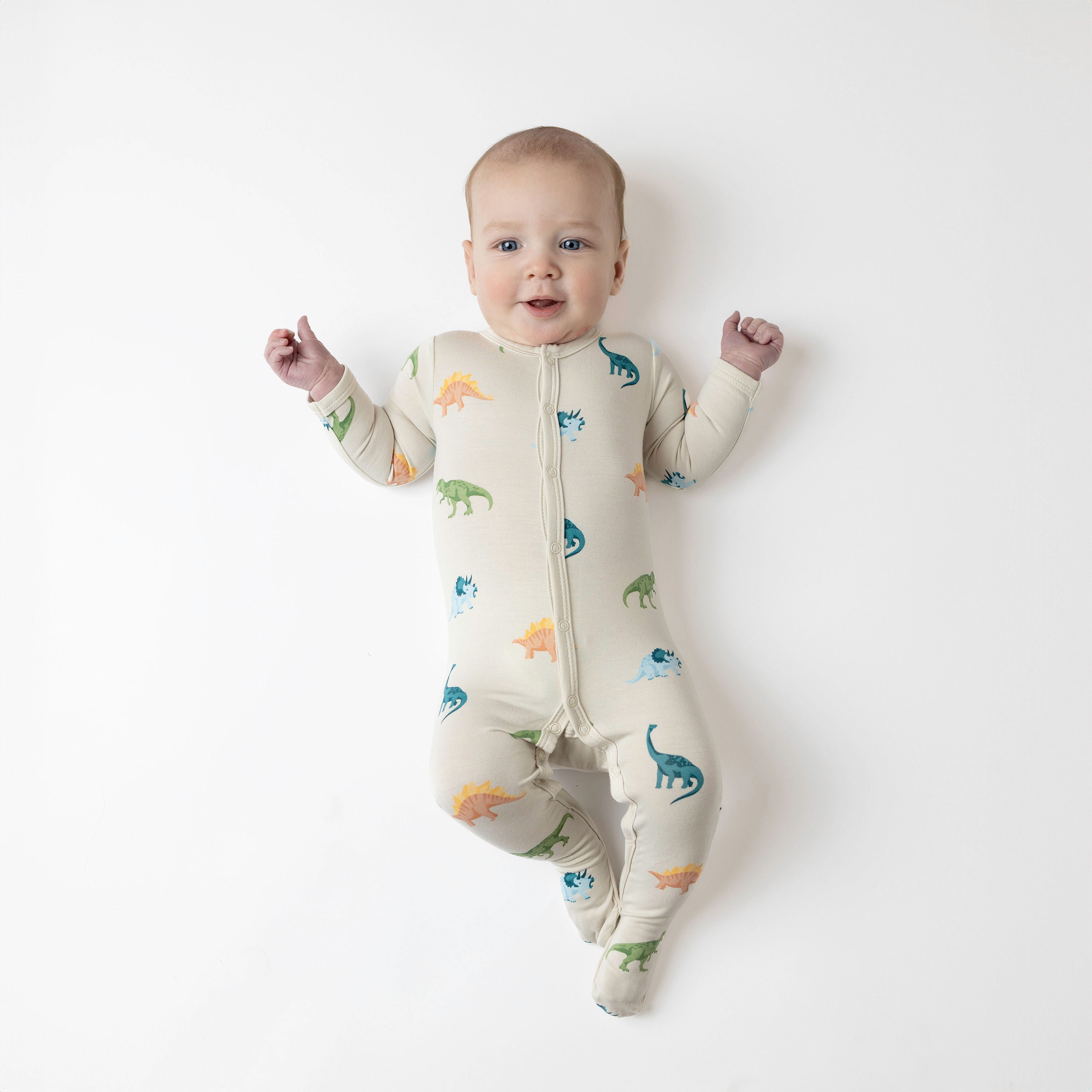Baby modeling snap footie in ecru roar