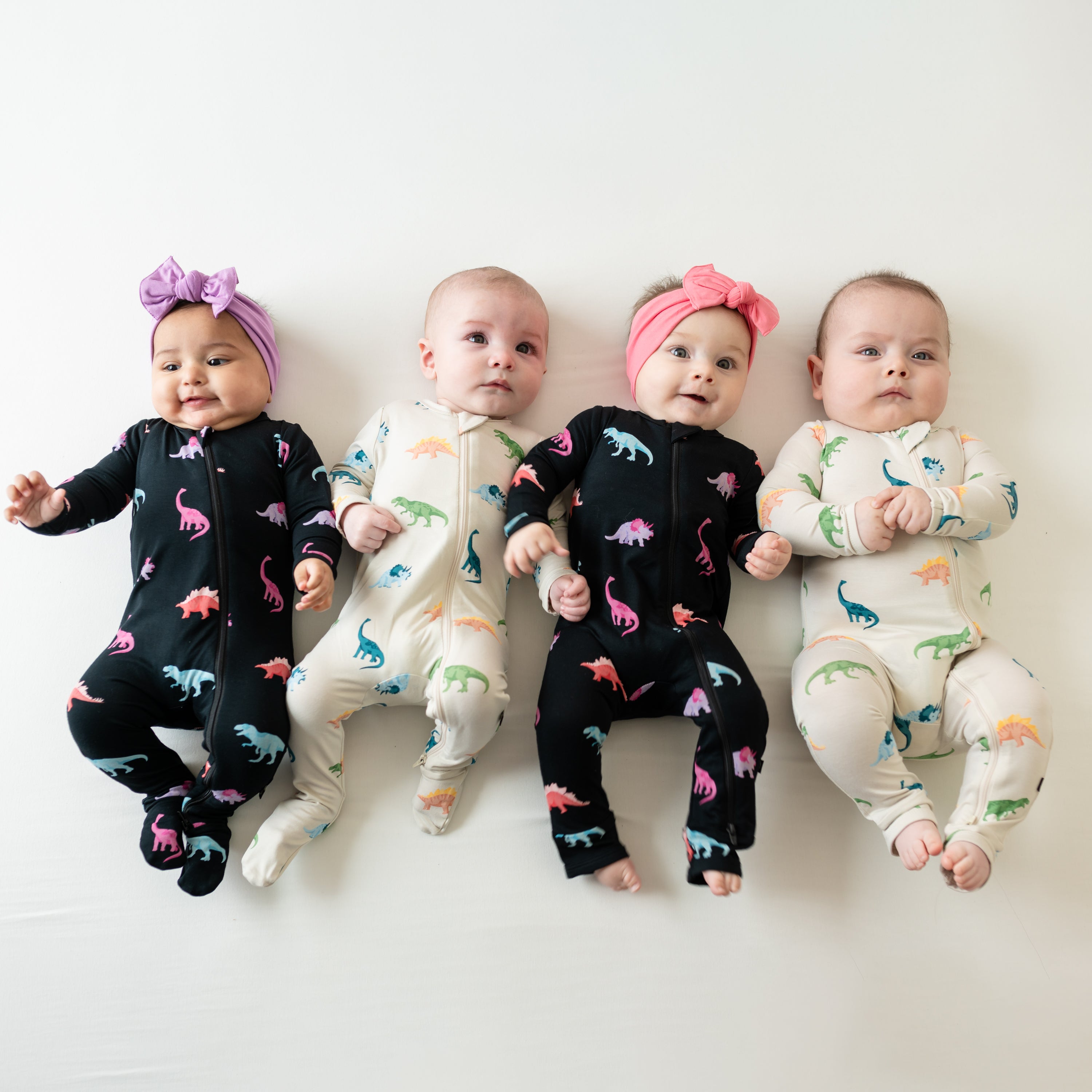 group of 4 babies in midnight and ecru roar footies and rompers