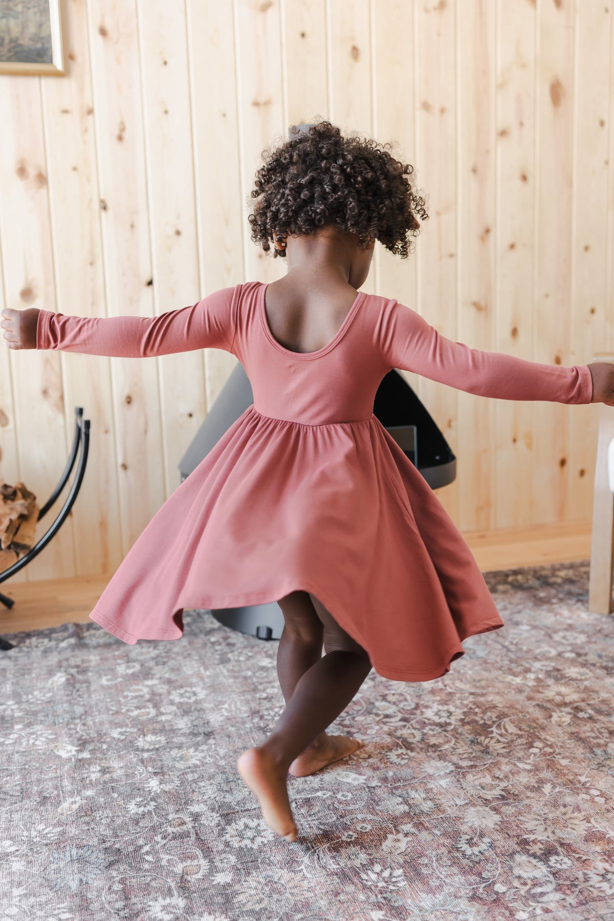 Girl Twirling in Long Sleeve Twirl Dress in Ember